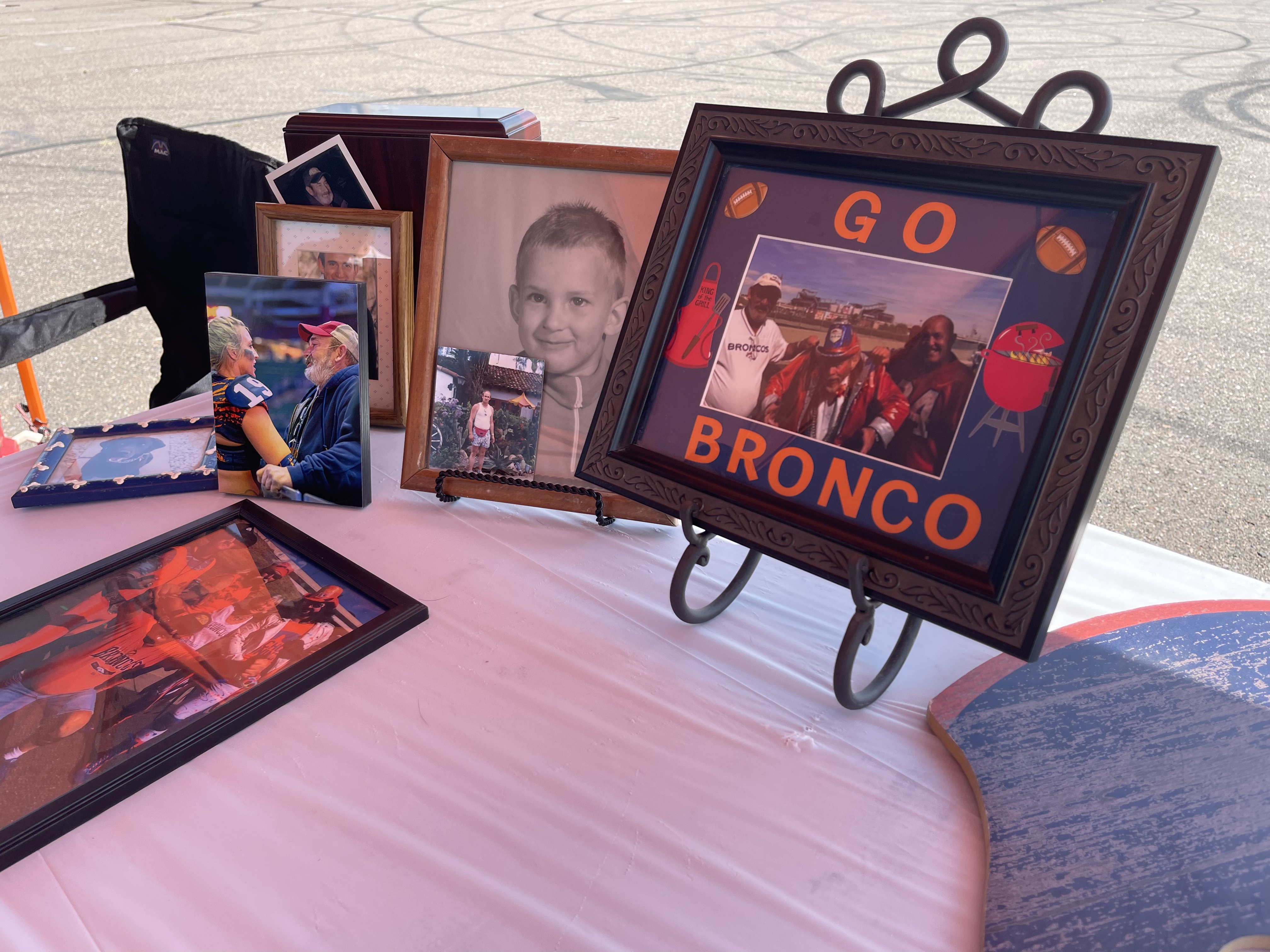 A small photo table to tribute Tim Look, a longtime Broncos season ticket holder at his family's tailgate on Saturday Aug. 28, 2021. (DavidMullenBreaking News Reporterdavid.mullen@gazette.comhttps://secure.gravatar.com/avatar/349fcb3ec304c9bbf2b50a05578938e7?d=mm&r=g)