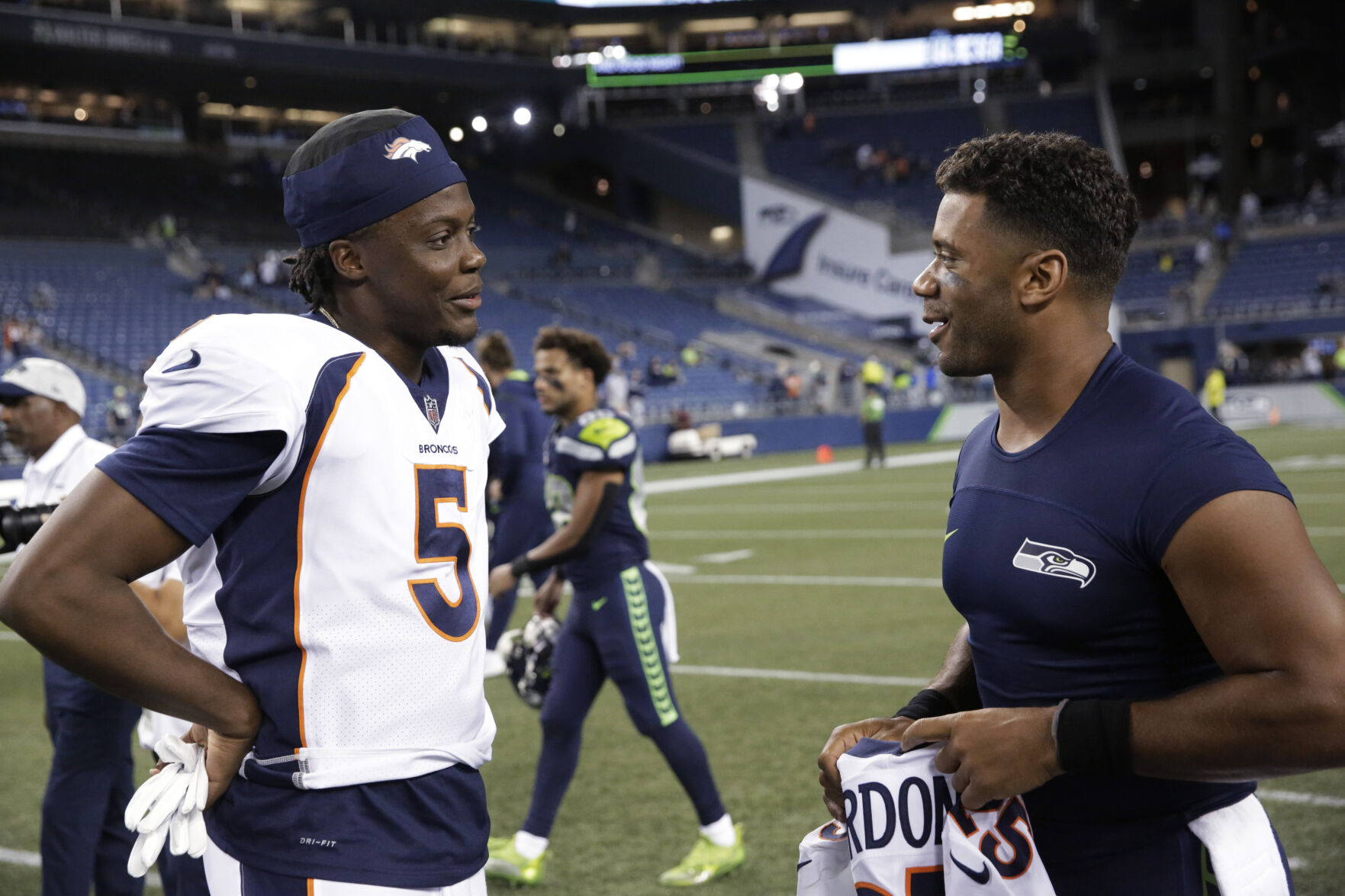 Seattle quarterback Russell Wilson, right, talks with Broncos quarterback Teddy Bridgewater after a game in Seattle. (The Associated Press)