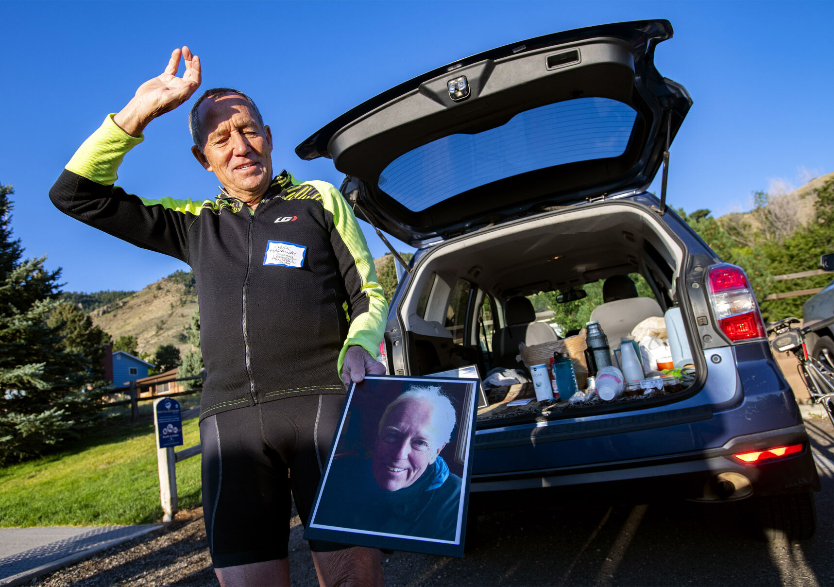 Chuck Haraway of cyclinglookoutmountain.org holds a photo of his friend and fellow cyclist Ray Bolton, who logged 7,915 rides to the top of Lookout Mountain before dying from COVID-19 on May 11, 2020. His last ride was five days before he entered the hospital. Bolton was known as “three-a-day Ray” because he often rode the 7,377-foot mountain three times in a day. (photos by Christian Murdock, The Gazette)