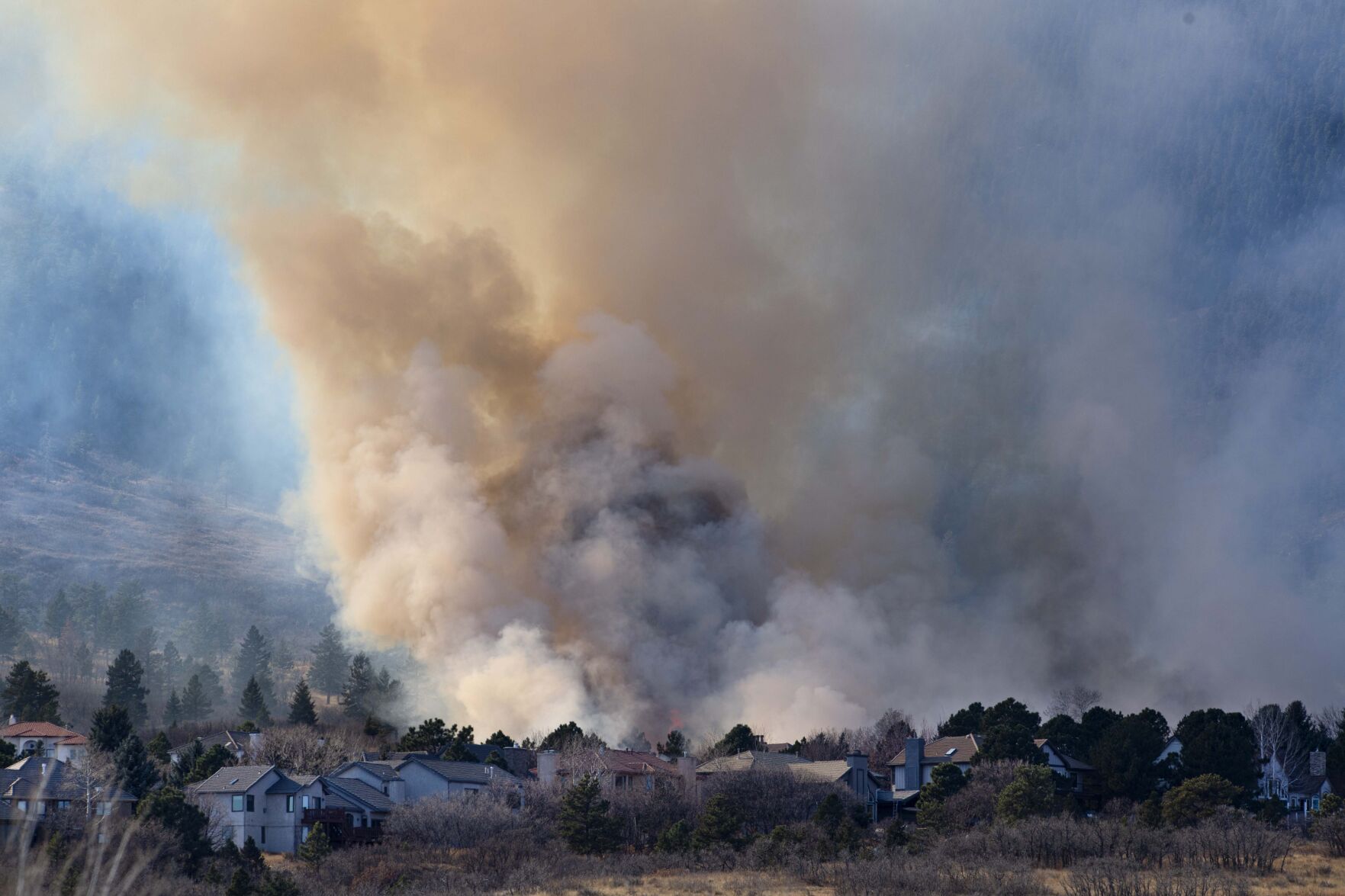 Flames rise above the rooftops as a wildfire burns near Bear Creek Regional Park on the westside of Colorado Springs on Nov. 19, 2020. ((Gazette file photo))