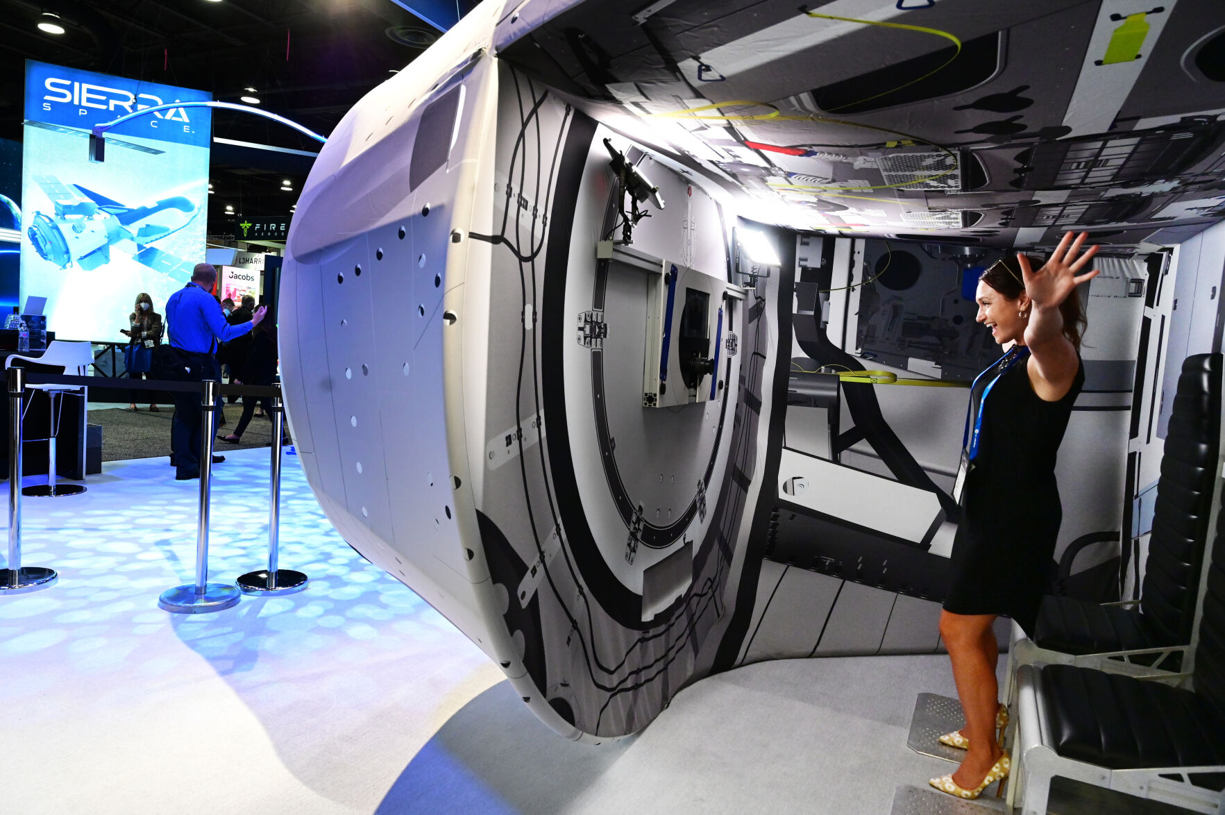 Meredith Garofalo with WeatherNation sees herself simulated as floating in space at one of Lockheed Martin exhibits at the Space Symposium on Tuesday, Aug. 24, 2021. (Photo by Jerilee Bennett, The Gazette) (JERILEE BENNETT THE GAZETTE)
