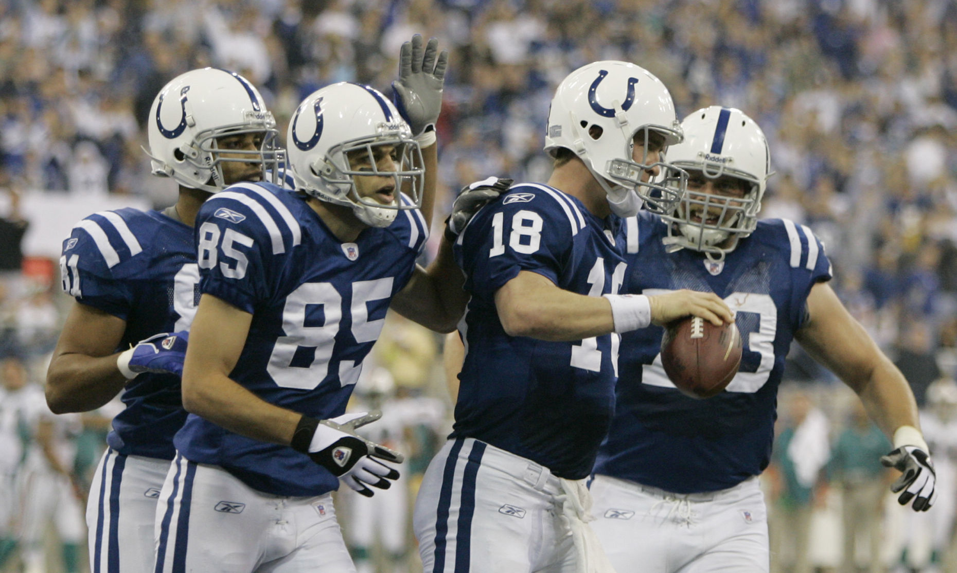 Indianapolis Colts quarterback Peyton Manning (18) celebrates an 11-yard touchdown with teammates Bryan Fletcher (81), Aaron Moorehead (85) and Jeff Saturday (63) during the second quarter of an NFL football game against the Miami Dolphins in Indianapolis, Sunday, Dec. 31, 2006. (AP Photo/Darron Cummings) (Darron Cummings)