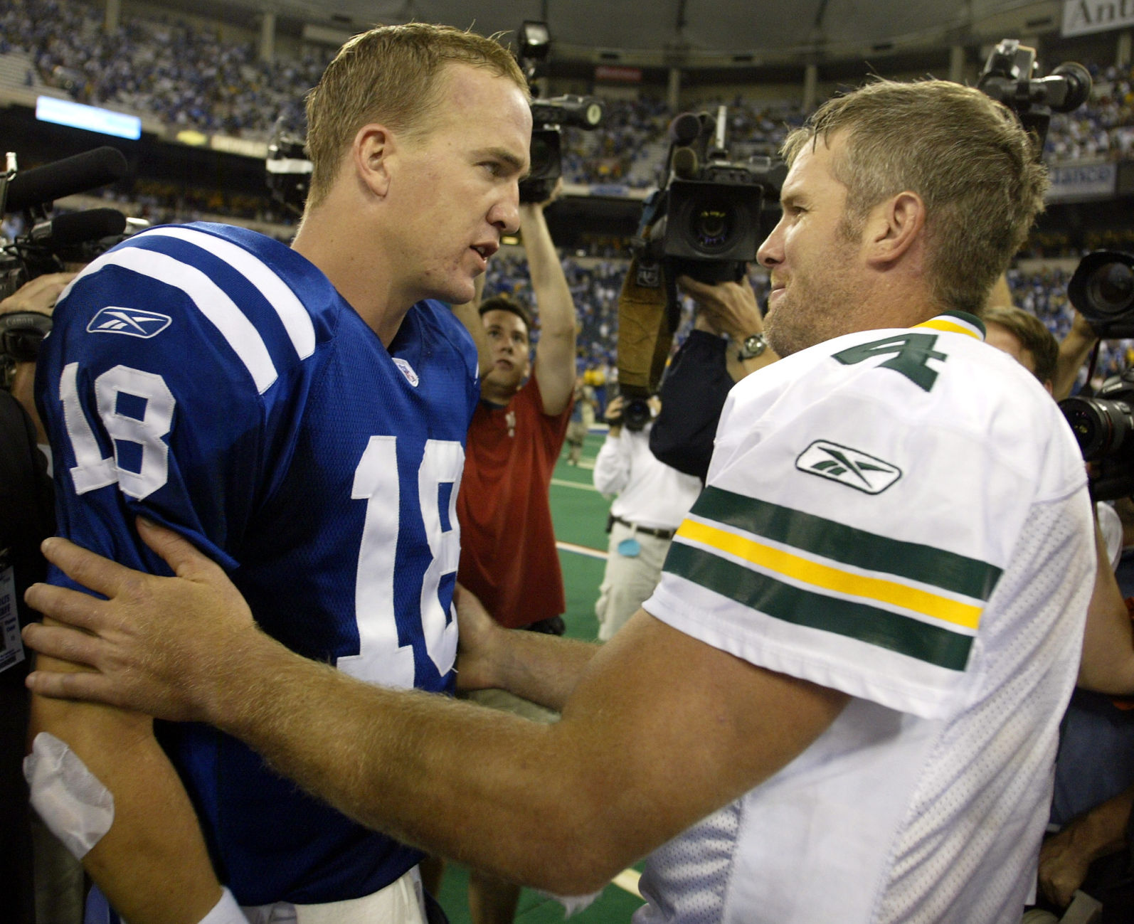 Indianapolis Colts quarterback Peyton Manning, left, meets with Green Bay Packers quarterback Brett Farve following a 45-31 Colts win in Indianapolis, Sunday, Sept. 26, 2004. (AP Photo/Michael Conroy) (MICHAEL CONROY)