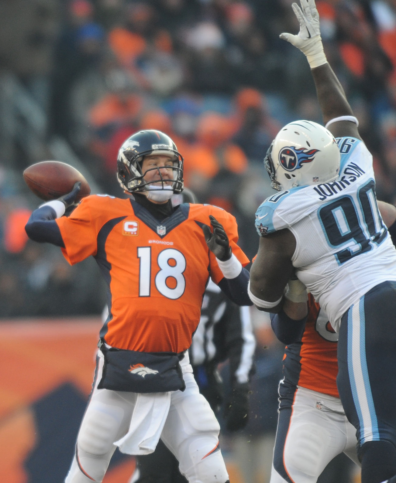Broncos quarterback gets off a pass as he is defended by Titans defensive tackle Antonio Johnson in the second quarter of a game. The Broncos played the Titans at Invesco Field at Mile High Stadium on Sunday, December 8, 2013. . (The Gazette/Jerilee Bennett) (JERILEE BENNETT)