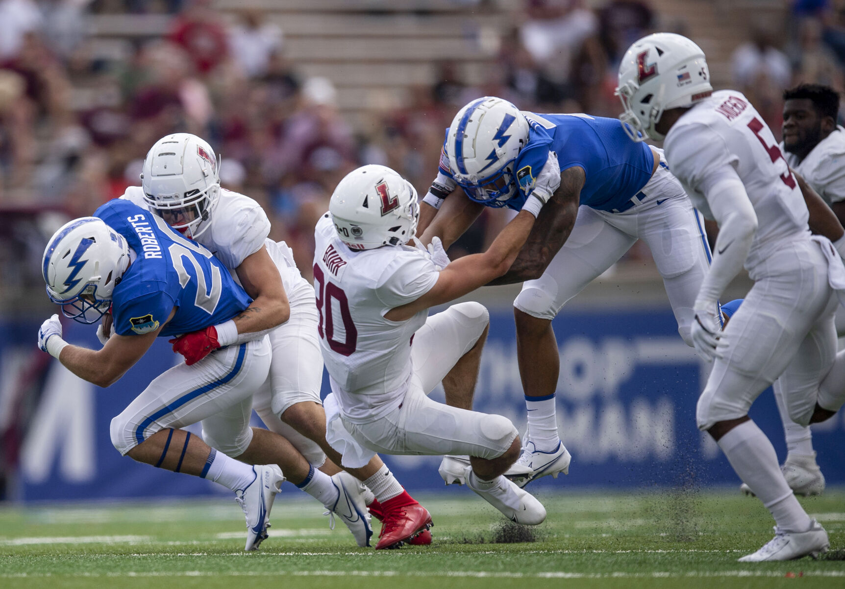 Air Force running back Brad Roberts (20) gets tackled by Lafayette Leopards Billy Shaeffer (21) during the Air Force home game at Falcon Stadium at the United States Air Force Academy in Colorado Springs, Colo. on Sept. 4, 2021. The Air Force Falcons won the game against the Lafayette Leopards by a score of 35-14. (Chancey Bush/ The Gazette) (Chancey Bush/ The Gazette)