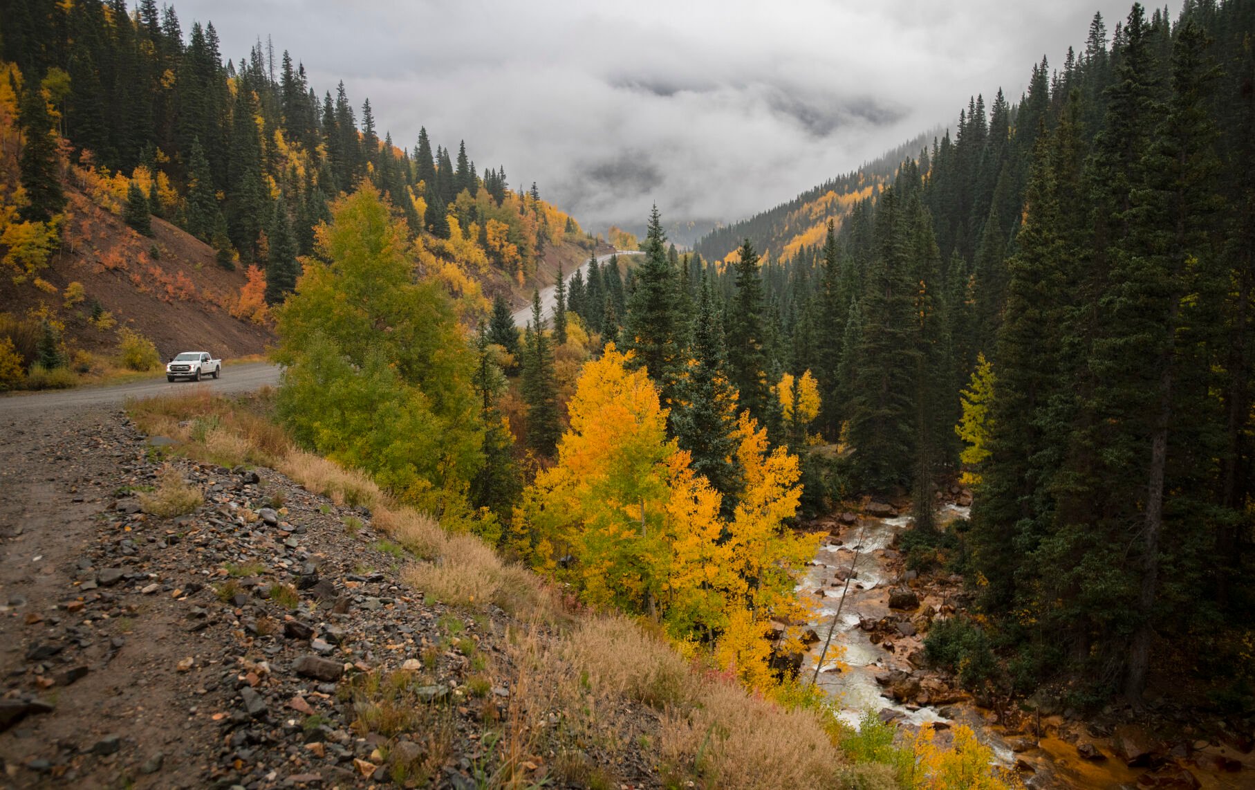 A truck drives through the turning aspens outside Silverton, Colo., Wednesday, Sept. 29, 2021, as a storm brings rain and snow to the San Juan Mountains in southwestern Colorado. (The Gazette, Christian Murdock) (Christian Murdock/The Gazette)