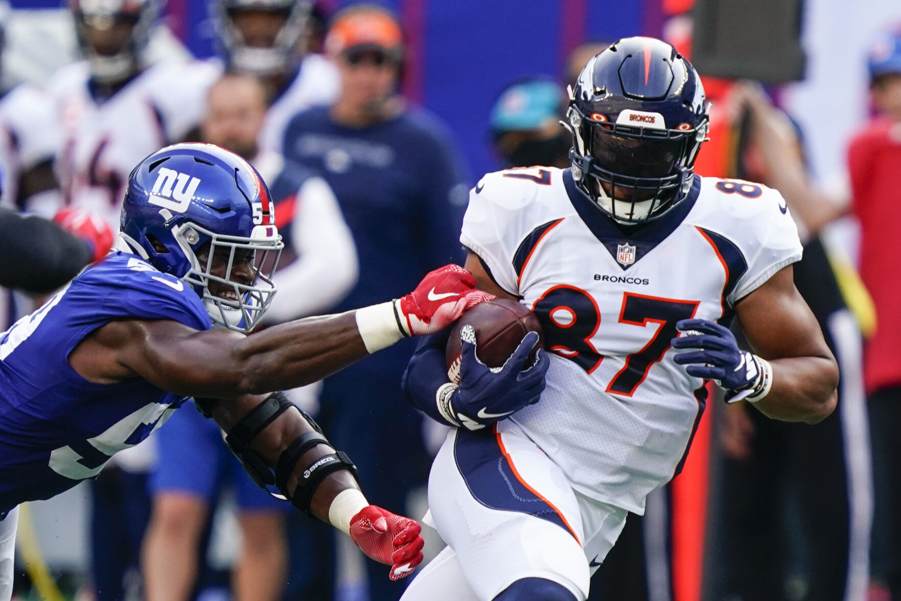 Denver Broncos tight end Noah Fant (87) protects the ball from New York Giants' Lorenzo Carter (59) during the first half of an NFL game Sunday, Sept. 12, 2021, in East Rutherford, N.J. (AP Photo/Matt Rourke) (GeorgeStoiaBroncos beat writergeorge.stoia@gazette.comhttps://secure.gravatar.com/avatar/5b8854c53e77d2068c18c16523197323?d=mm&r=g)