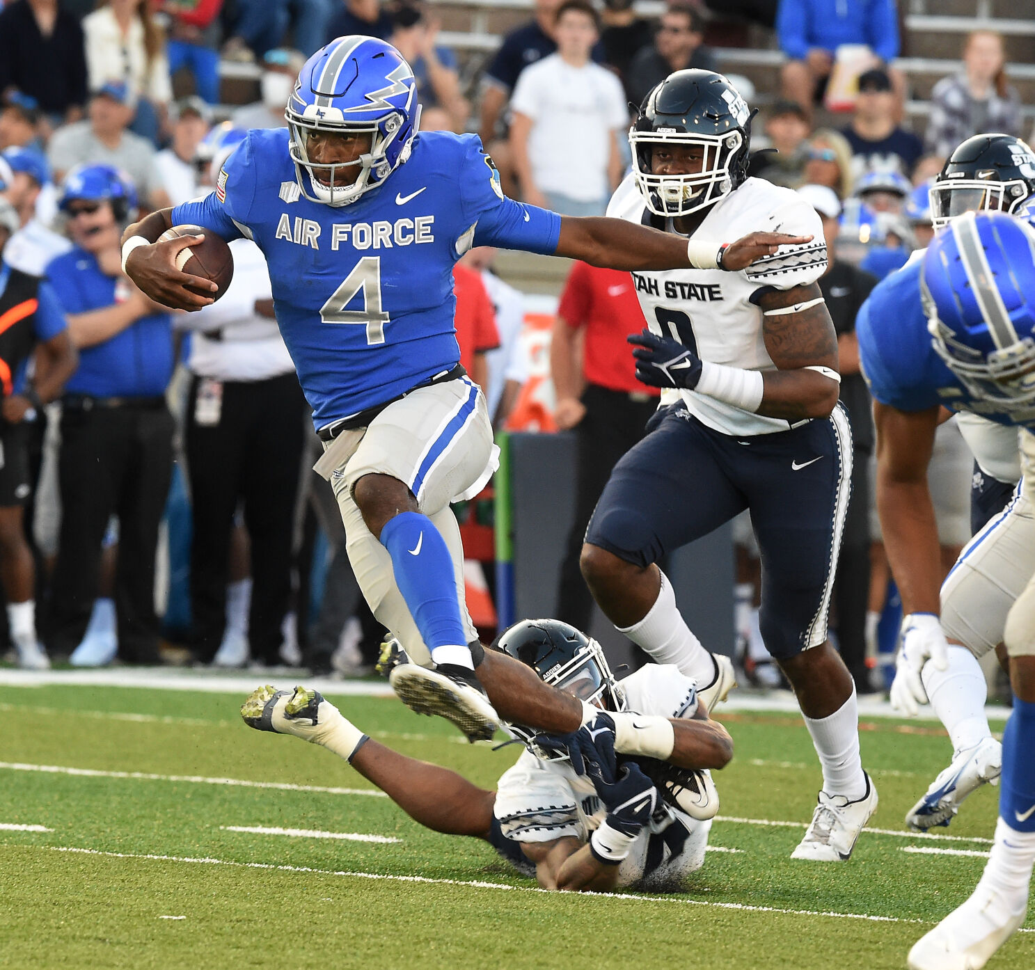Air Force quarterback Haaziq Daniels breaks the tackle of Utah State defenders during the first quarter of a game at Falcon Stadium in Colorado Springs, Colorado on Saturday, Sept. 18, 2021. (Photo by Jerilee Bennett, The Gazette) (JERILEE BENNETT, THE GAZETTE)