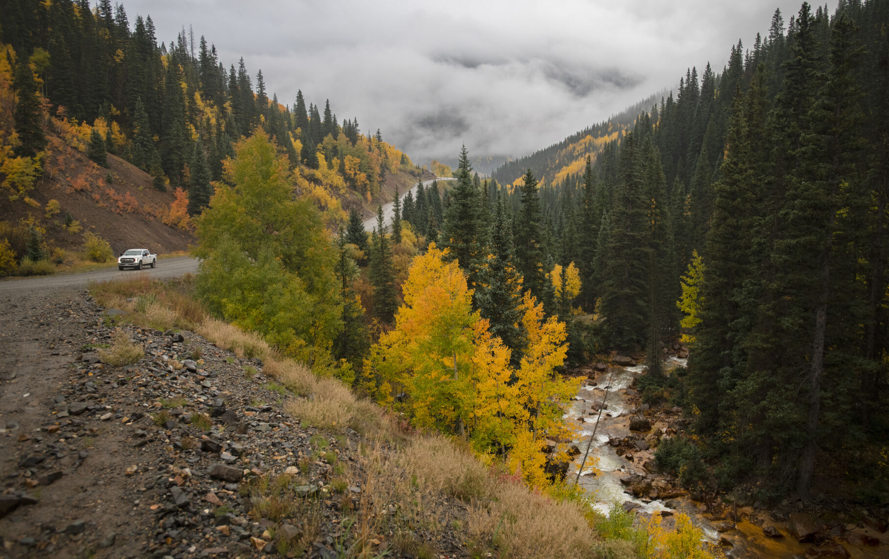 A truck drives through the turning aspens outside Silverton, Colo., Wednesday, Sept. 29, 2021, as a storm brings rain and snow to the San Juan Mountains in southwestern Colorado. (The Gazette, Christian Murdock) (Christian Murdock/The Gazette)