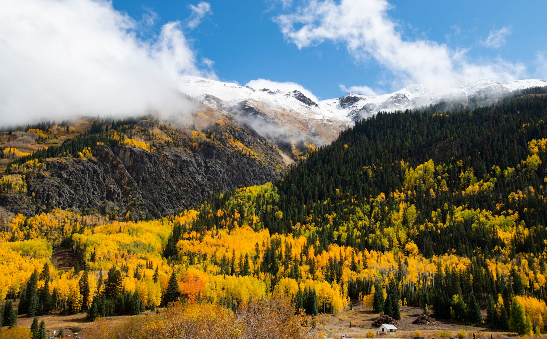 The clouds break after a storm exposing the snow-capped mountains and the turning aspens outside Ouray, Colo., Wednesday, Sept. 29, 2021. (The Gazette, Christian Murdock) (Christian Murdock/The Gazette)