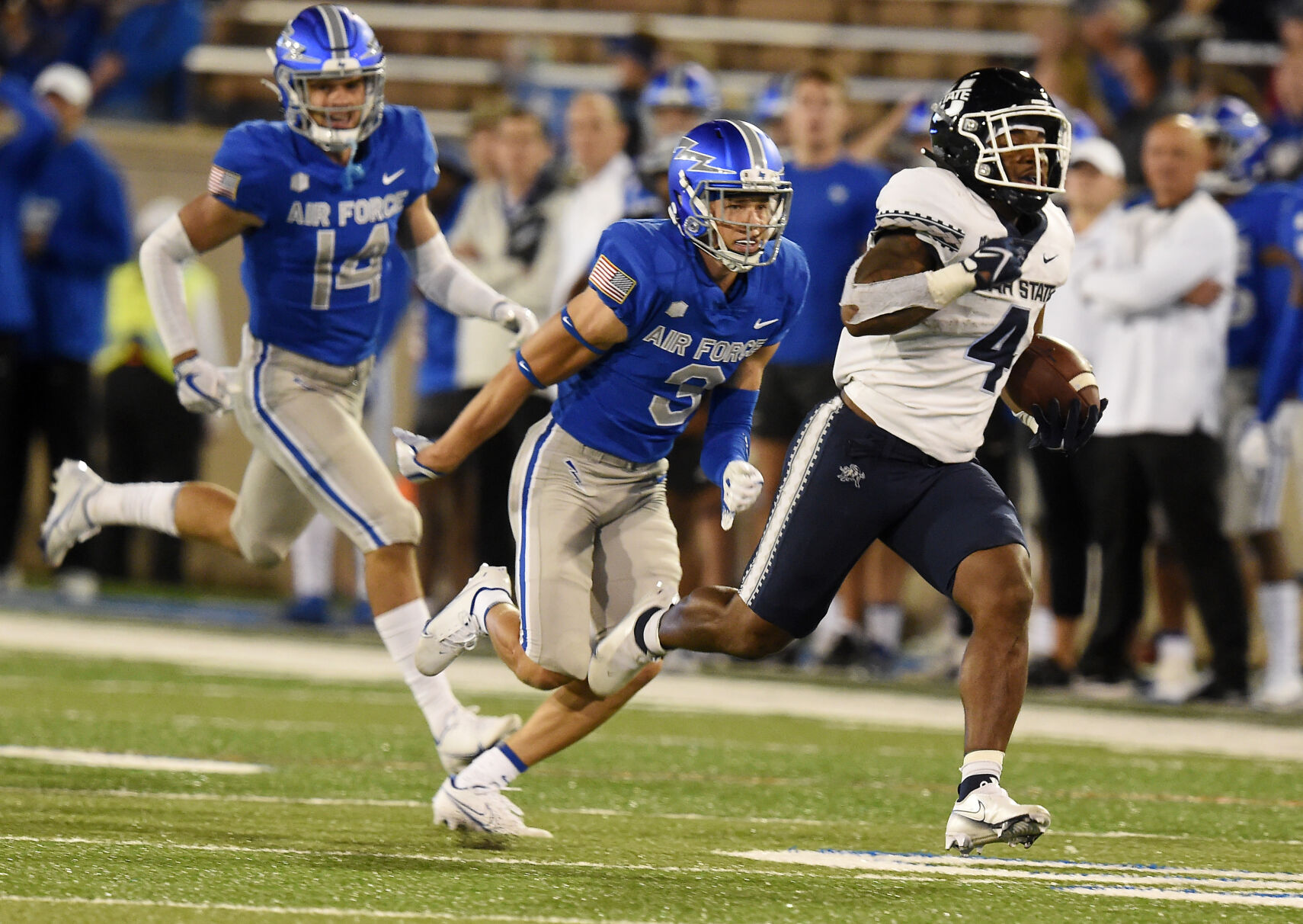 Utah State running back Calvin Tyler, Jr. leaves Air Force defensive players Ethan Erickson and Tre Bugg III in the dust for the game winning touchdown during the fourth quarterr of a game at Falcon Stadium in Colorado Springs, Colorado on Saturday, Sept. 18, 2021. Air Force lost the heartbreaker 49-45. (Photo by Jerilee Bennett, The Gazette) (JERILEE BENNETT, THE GAZETTE)