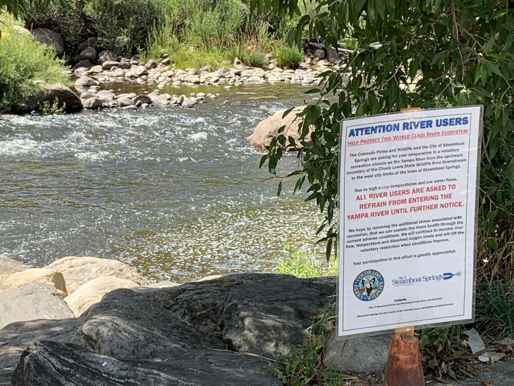 A closure notification is posted along the Yampa. The river has been voluntarily closed to recreational activity within Steamboat Springs since July 8. The causes: low stream flows and too high temperatures that endanger river life. (MarianneGoodlandmarianne.goodland@coloradopolitics.comhttps://secure.gravatar.com/avatar/125a14b7bd9266f61a445ec13b1d3605?d=mm&r=g)