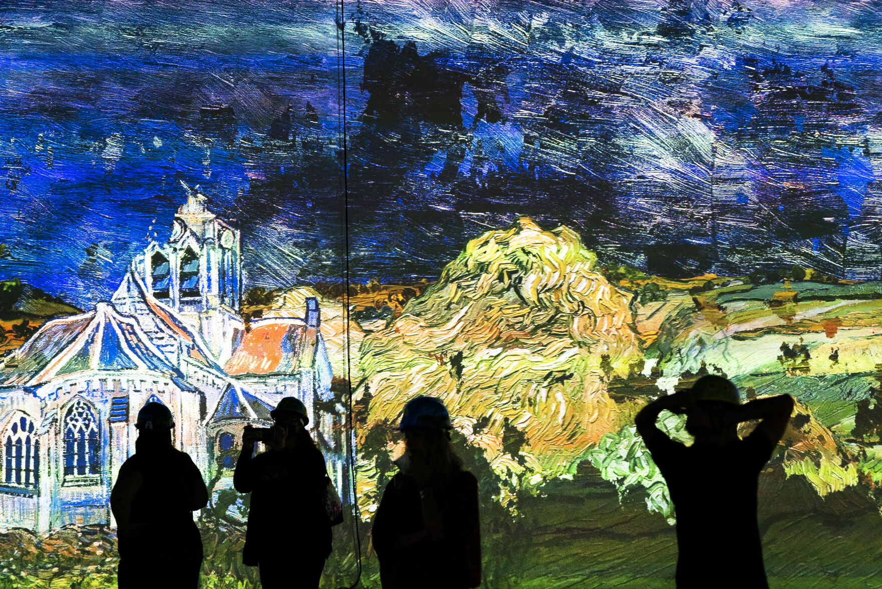 Guests experience a 10 minute example of the immersive experience during a hard hat tour of the new Immersive Van Gogh Exhibit Denver at Lighthouse Denver, just west of the River North Art District on Wednesday, September 22, 2021. (Photo by Katie Klann/Denver Gazette) (Katie Klann The Gazette)