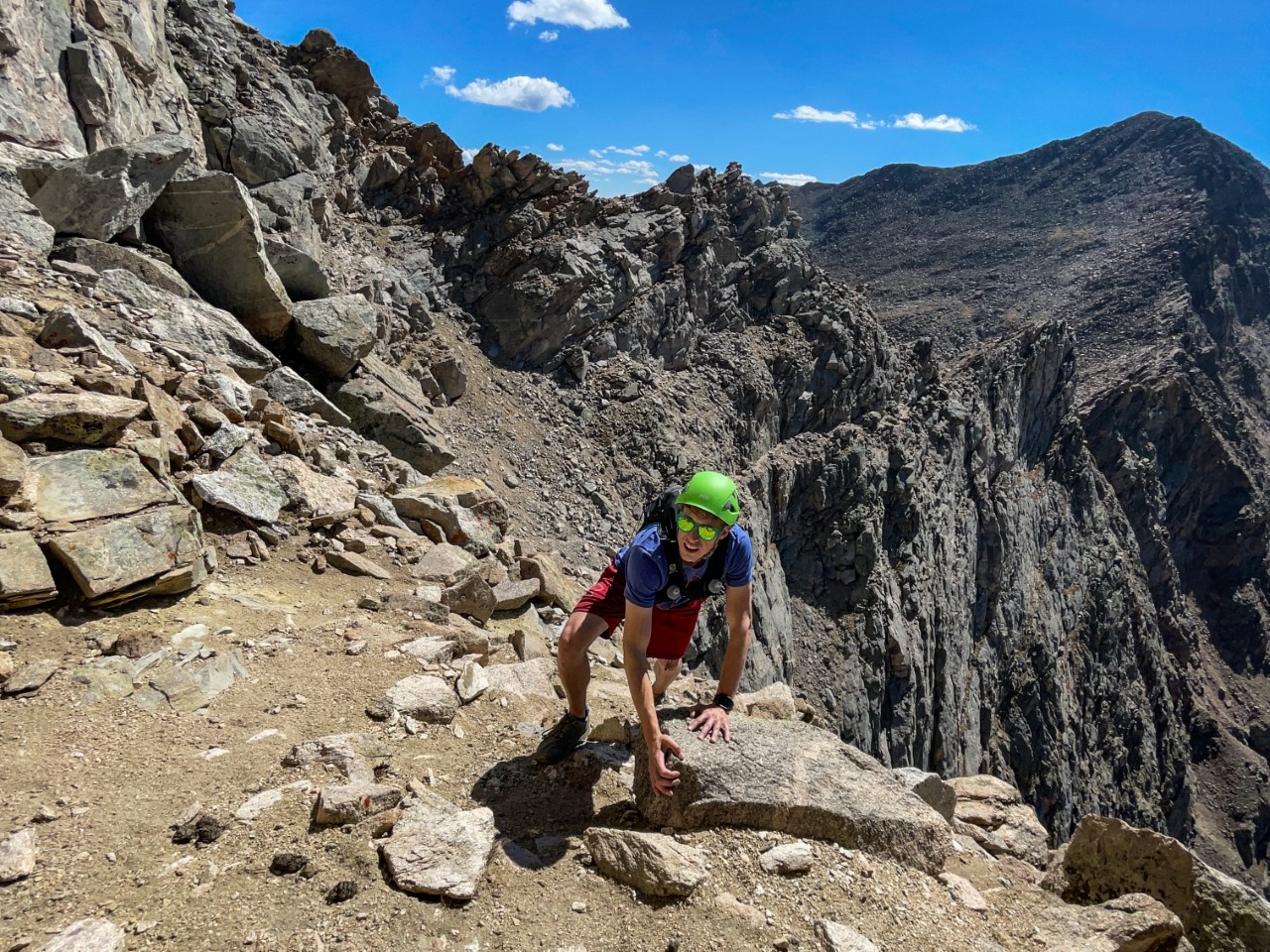 Spencer McKee approaches the final push of the Sawtooth Ridge. The ridge itself can be see directly behind him, along with a white line coming off of the upper right of his helmet that is part of the trail. The Mount Bierstadt summit can be see in the top right corner of the image. This route features big drops and exposure, along with plenty of route-finding. Do not attempt this time unless you have prior experience on similar terrain.