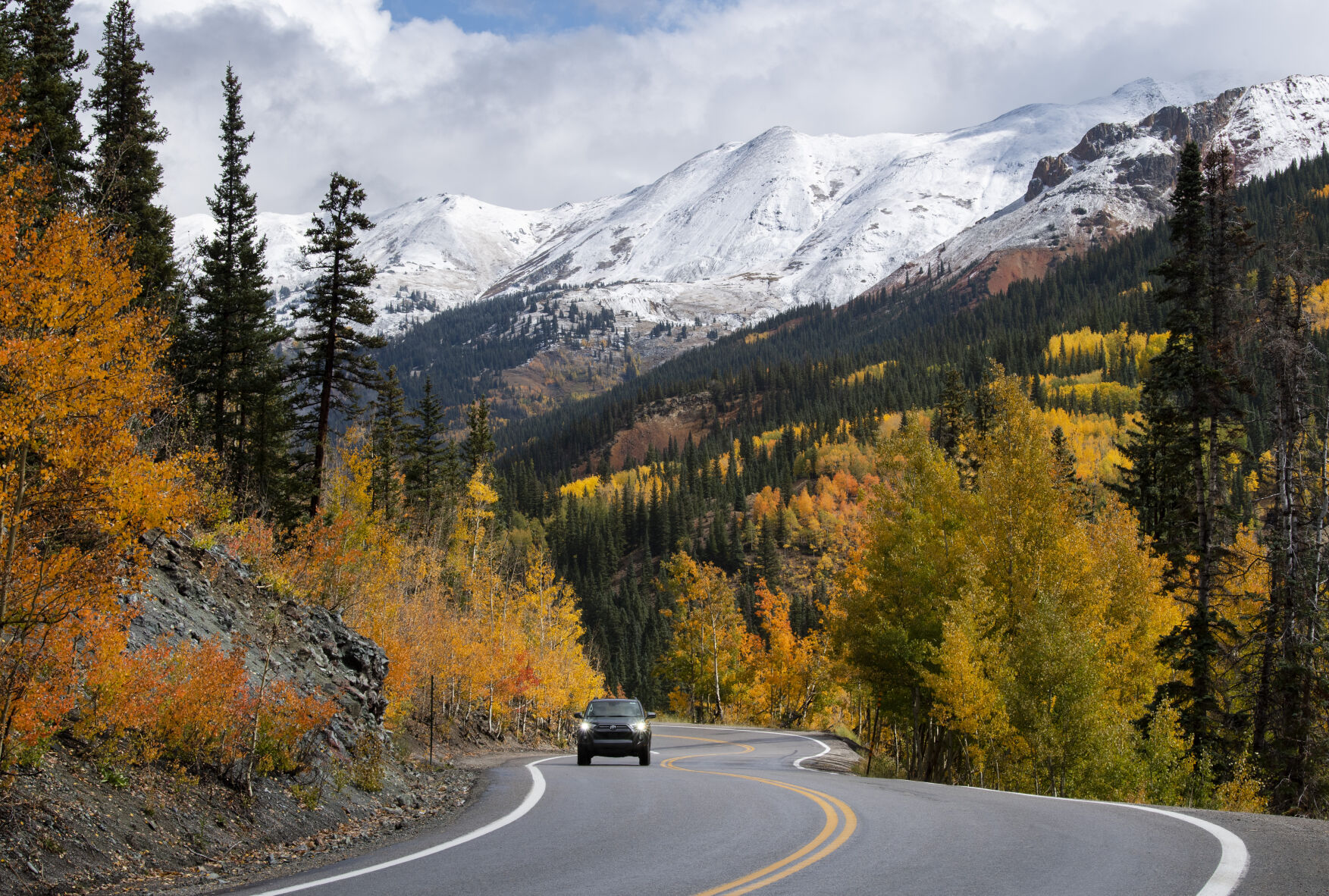 A car drives over 11,018-foot Red Mountain Pass between Silverton and Ouray, Colo., Wednesday, Sept. 29, 2021, as the aspens turn to gold. (The Gazette, Christian Murdock) (Christian Murdock/The Gazette)