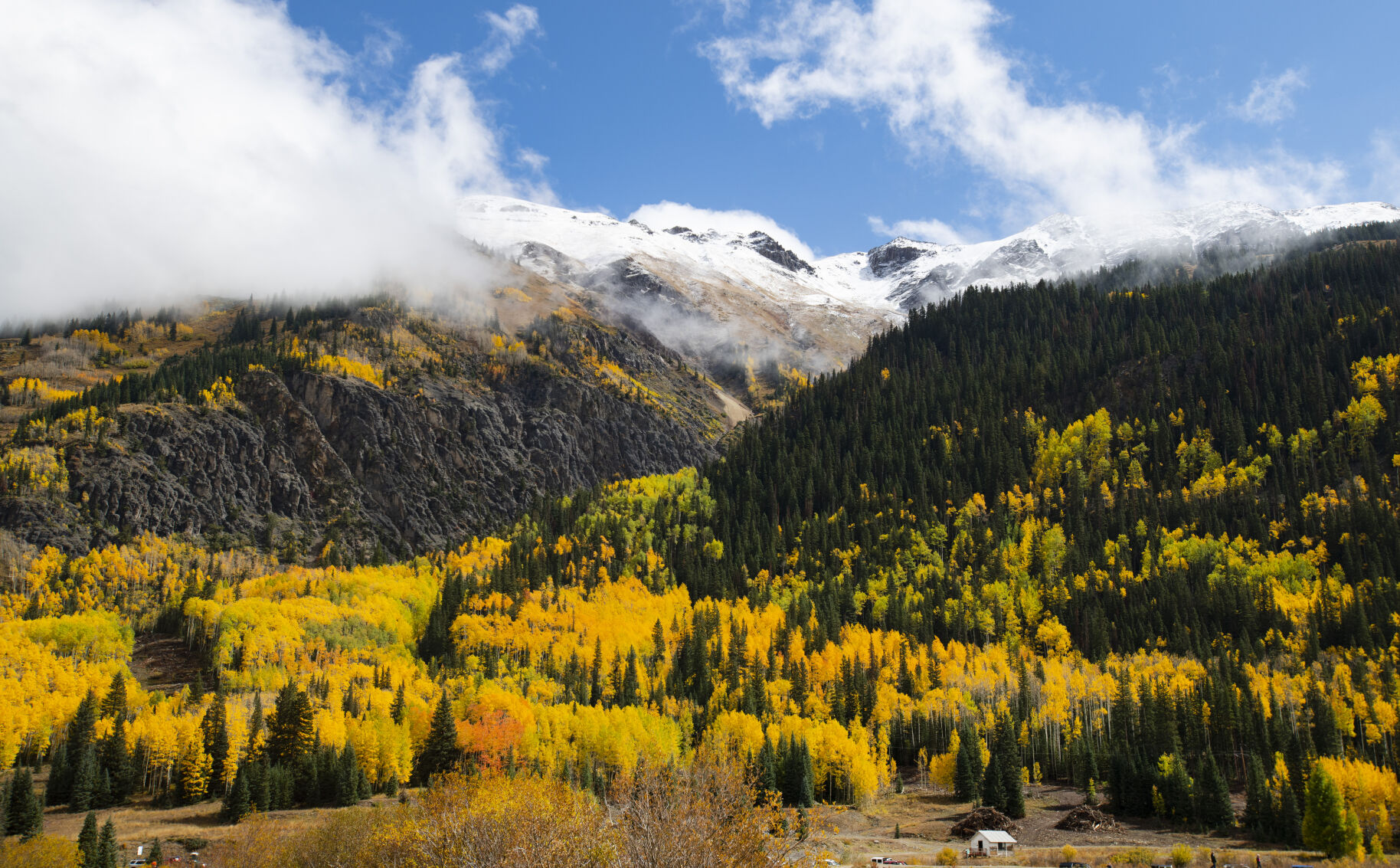 The clouds break after a storm exposing the snow-capped mountains and the turning aspens outside Ouray, Colo., Wednesday, Sept. 29, 2021. (The Gazette, Christian Murdock) (Christian Murdock/The Gazette)