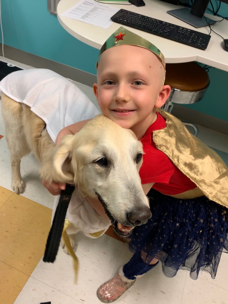 Piper Lardes with Ralph the support dog at Children’s Hospital Colorado. (Photo courtesy of the Lardes family.)