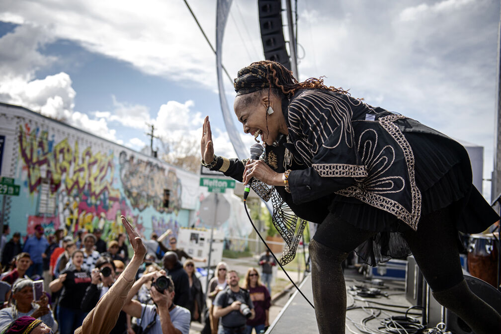 A jazz performer high fives an audience member during the 2019 Five Points Jazz Festival in Denver, Colo. (Lucia De Giovanni/ Denver Arts and Venues)