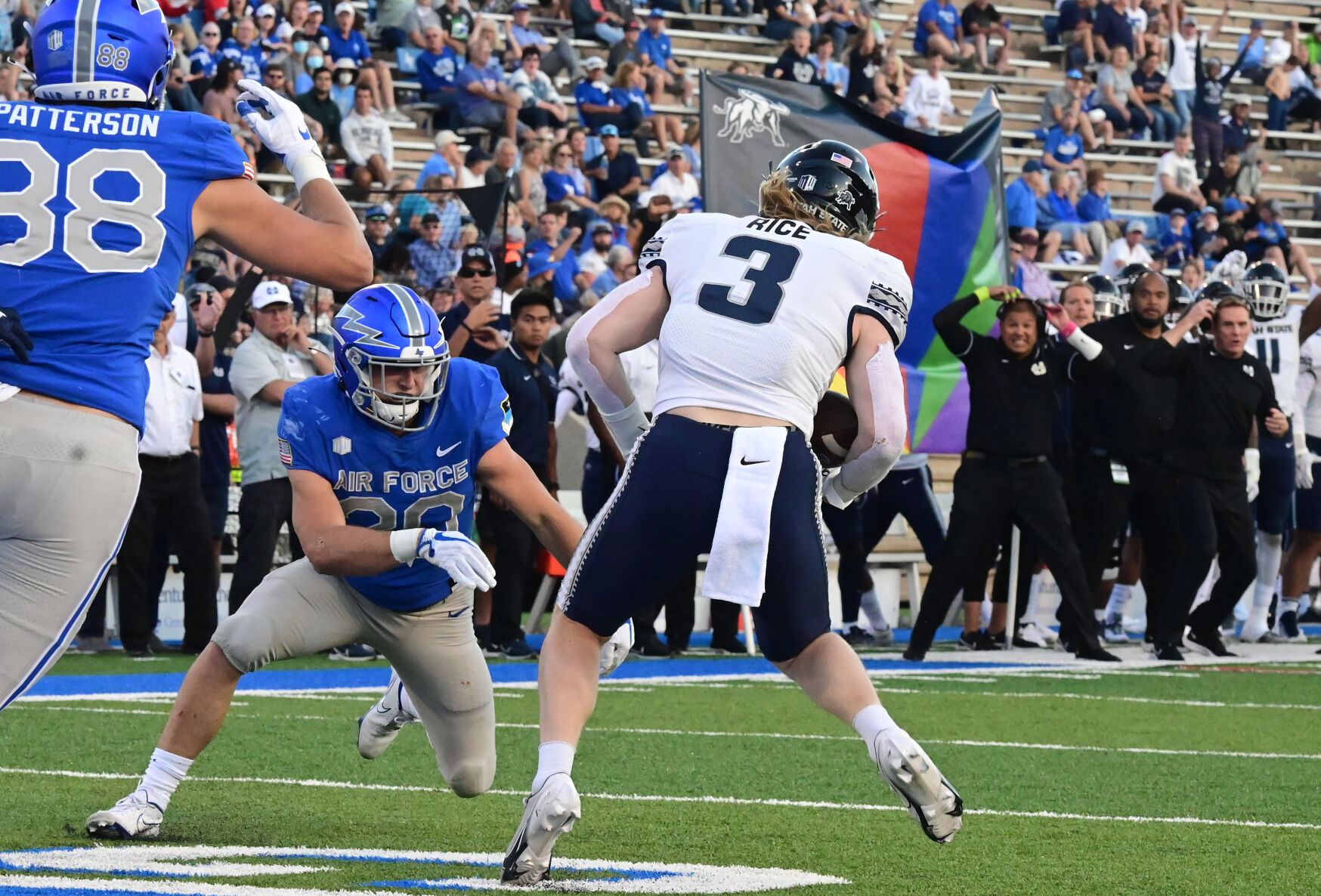 Air Force running back Brad Roberts (center) and tight end Kyle Patterson go after Utah State linebacker Justin Rice after he intercepted the ball in the end zone during the 2nd quarterr of a game at Falcon Stadium in Colorado Springs, Colorado on Saturday, Sept. 18, 2021. Air Force lost the heartbreaker 49-45. (Photo by Jerilee Bennett, The Gazette) (JERILEE BENNETT, THE GAZETTE)