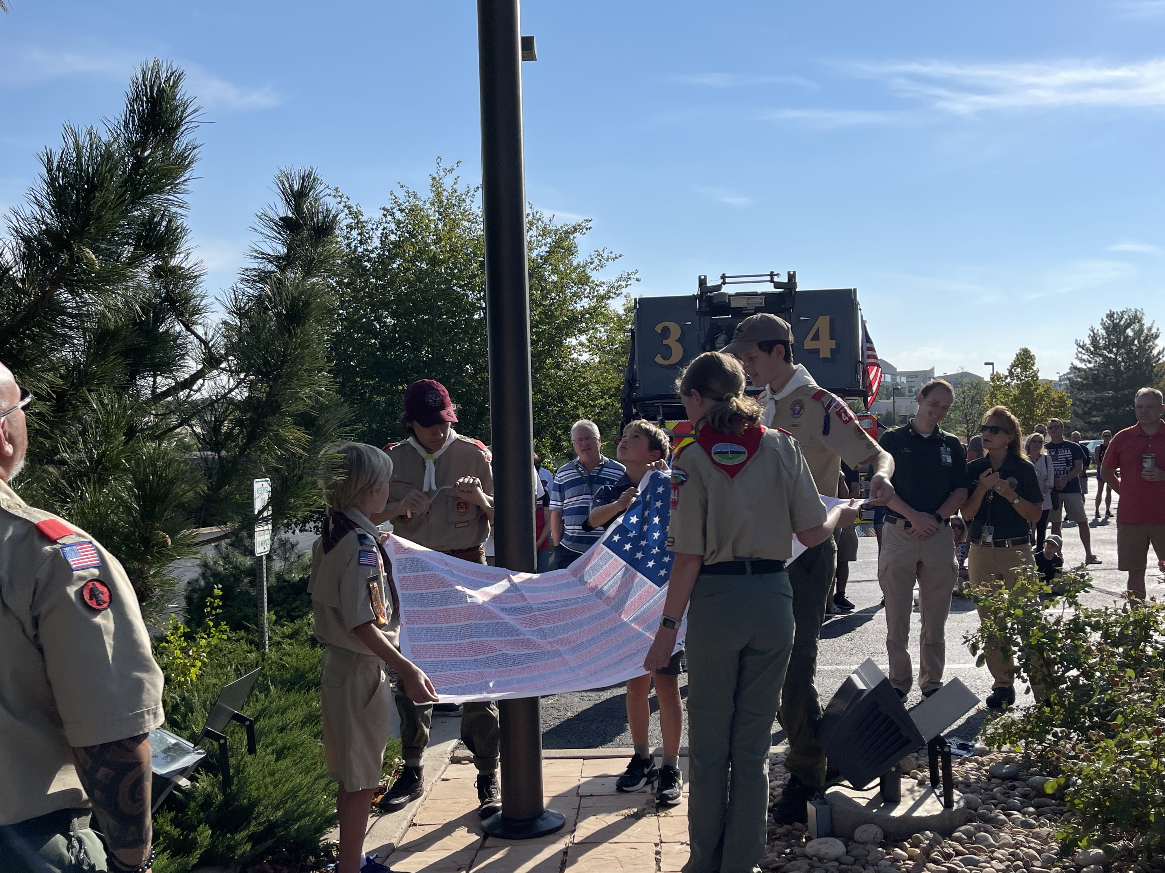 A handful of members of Boy Scouts Troop 444 rose the honor flag shortly after 9 a.m. Each of the seven red stripes on the American flag were the names of the 2,977 people who died 20 years ago. (DavidMullenBreaking News Reporterdavid.mullen@gazette.comhttps://secure.gravatar.com/avatar/349fcb3ec304c9bbf2b50a05578938e7?d=mm&r=g)