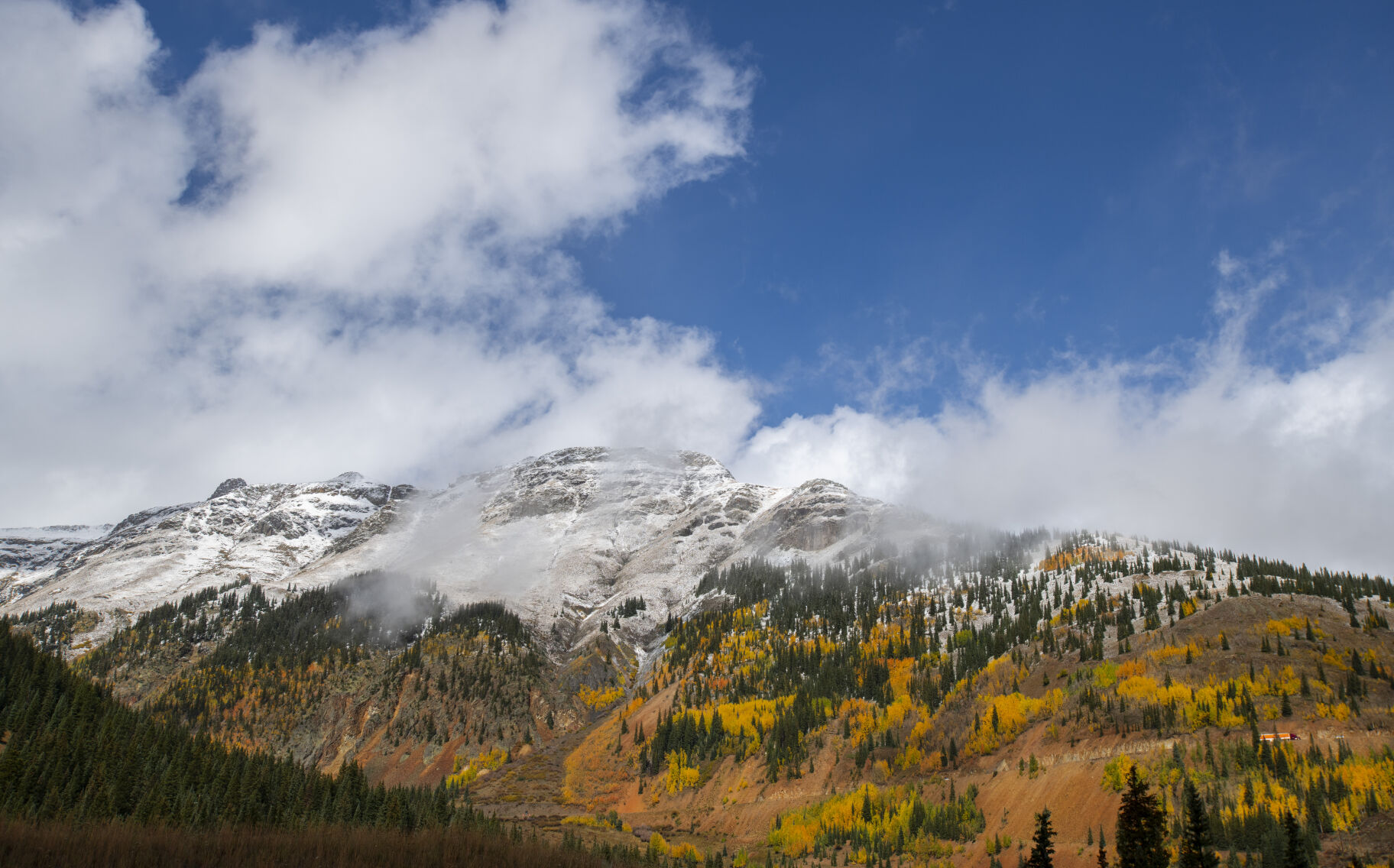 The clouds break revealing the snow-capped mountains on 11,018-foot Red Mountain Pass between Silverton and Ouray, Colo., Wednesday, Sept. 29, 2021. (The Gazette, Christian Murdock) (Christian Murdock/The Gazette)
