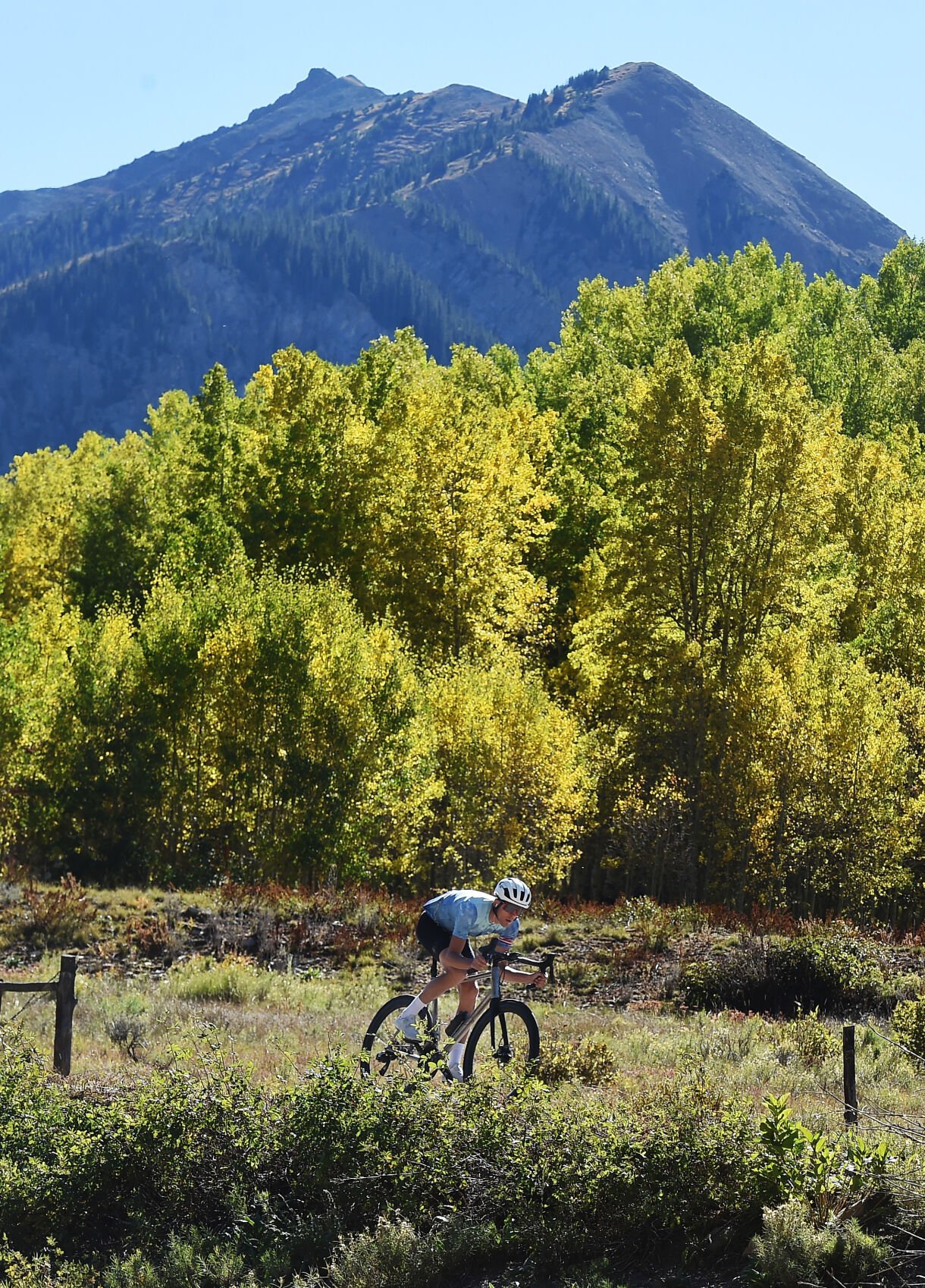 A cyclist takes advantage of a beautiful day and beautiful scenery on Castle Creed Rd. on Wednesday, Sept. 22, 2021. The Fall colors are putting on a show, but mostly at the higher elevations. Castle Creek Rd. is located south of Aspen. (Photo by Jerilee Bennett, The Gazette) (Jerilee Bennett)