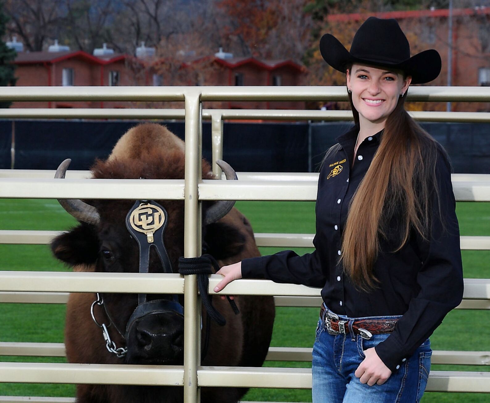Taylor Stratton, a 2009 Cheyenne Mountain High School graduate, stands with Ralphie V in 2016, when she was assistant manager of CU’s Ralphie Live Mascot Program. She became the program manager last year. (courtesy of Bryce Boyer)