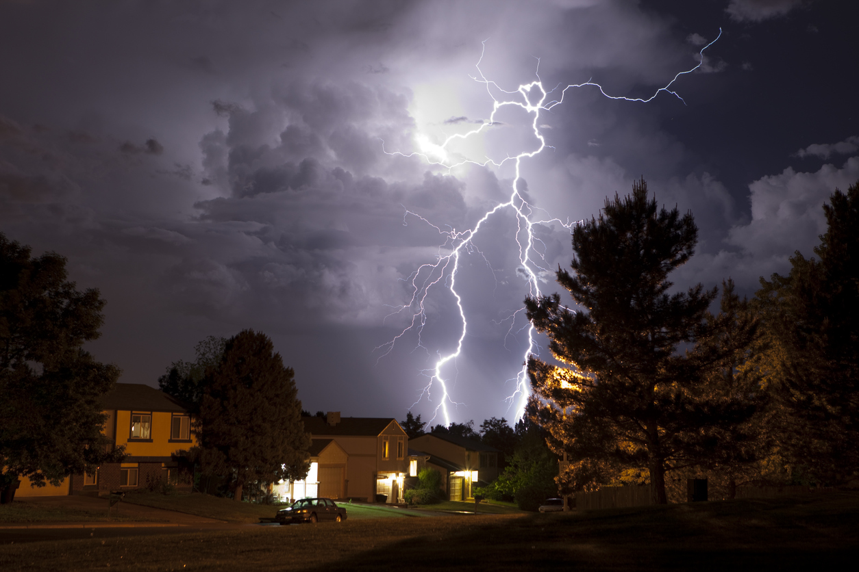 Lightning fills the sky above homes in the Denver metro area. Photo Credit: milehightraveler (iStock). (milehightraveler)