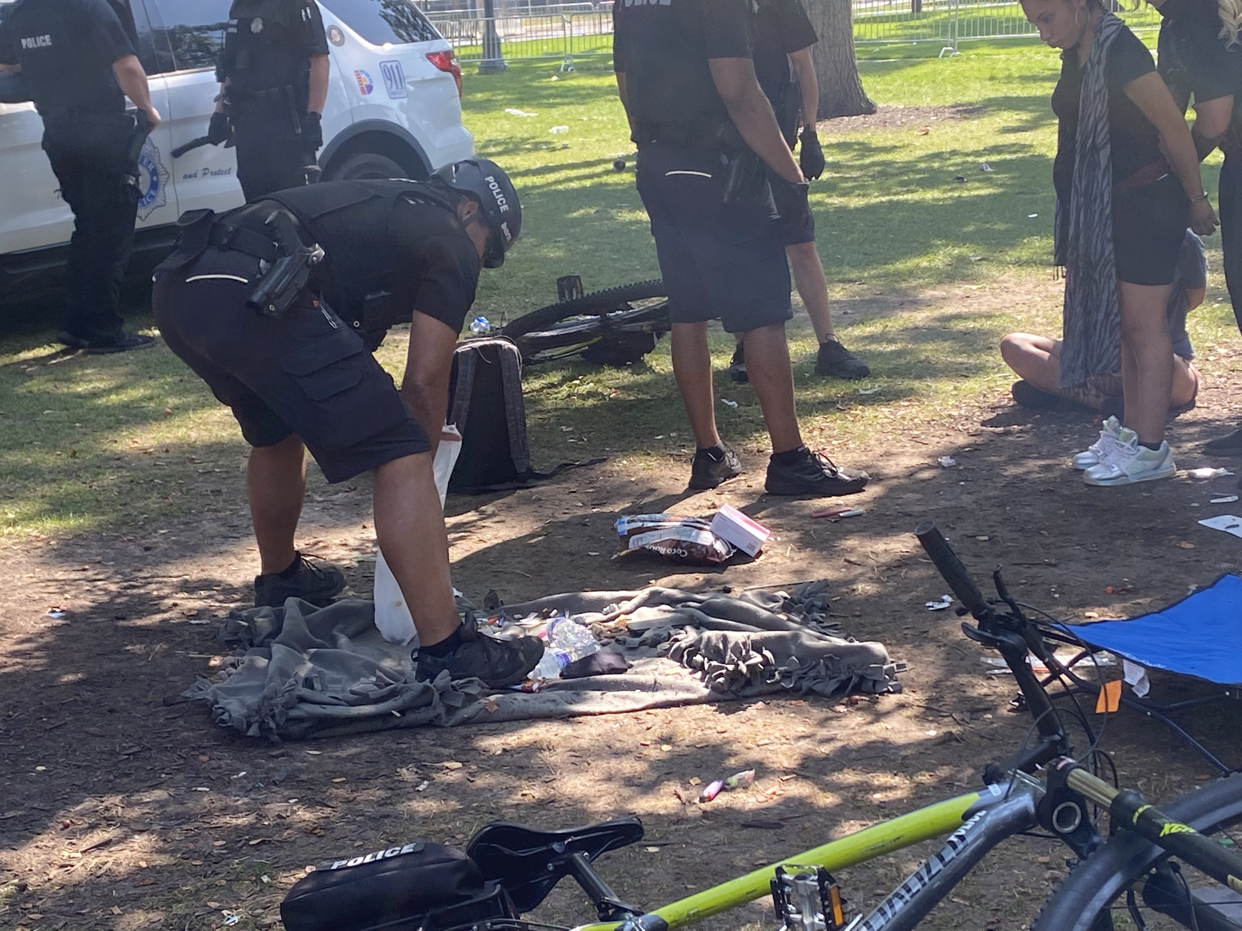 Denver police officers go through the backpack of a suspect in Civic Center Park Thursday. (CarolMcKinleyDenver Enterprise Reportercarol.mckinley@gazette.comhttps://denvergazette.com/content/tncms/avatars/5/c3/a0f/5c3a0fbe-1007-11ec-9e18-b7f42cfa4b0f.9565a0ce58866e86bcf18260621c2a46.png)