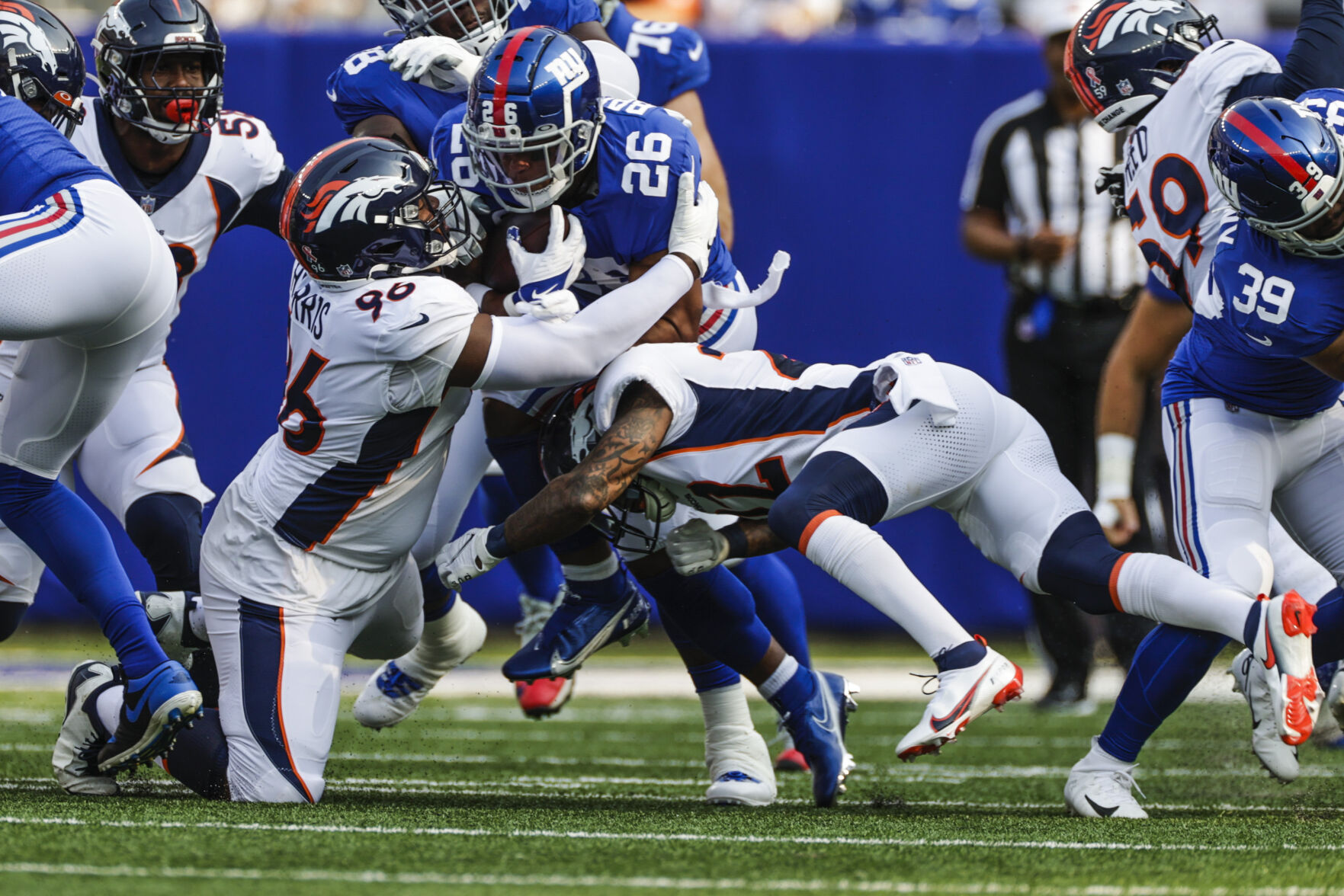 Giants running back Saquon Barkley, center, is tackled by Broncos defensive end Shelby Harris, left, and safety Kareem Jackson during the first half Sunday in East Rutherford, N.J. (GeorgeStoiaBroncos beat writergeorge.stoia@gazette.comhttps://secure.gravatar.com/avatar/5b8854c53e77d2068c18c16523197323?d=mm&r=g)