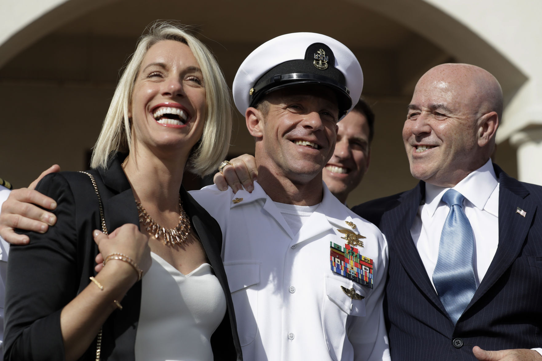Navy Special Operations Chief Edward Gallagher, center, walks with his wife, Andrea, and adviser, Bernard Kerik, as they leave a military court in July. (the associated press/)
