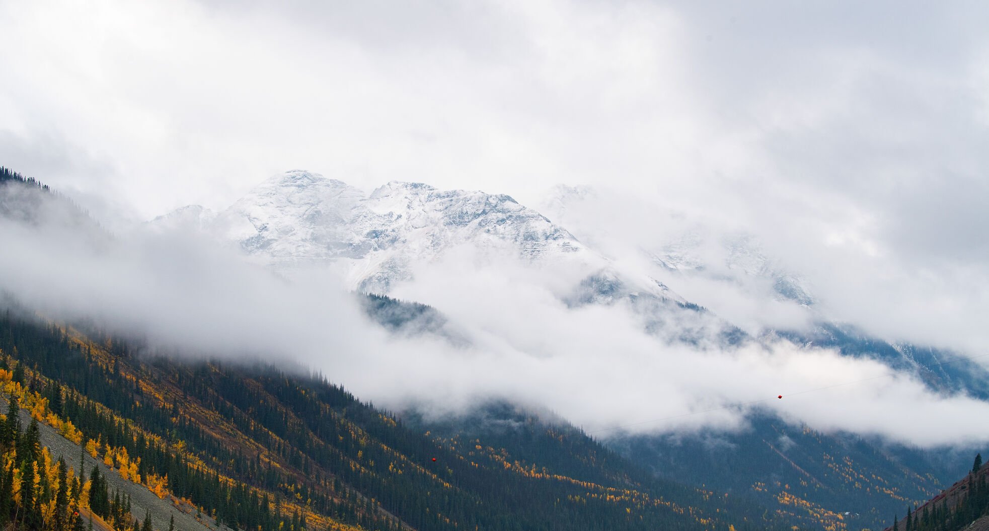 The snow-capped mountains outside Silverton, Colo., peek through the clouds on a wet fall day Wednesday, Sept. 29, 2021. (The Gazette, Christian Murdock) (Christian Murdock/The Gazette)