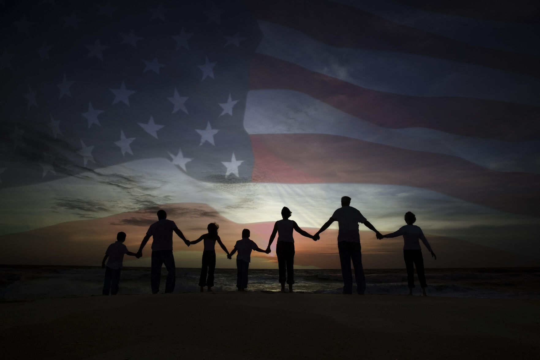 People holding hands with American flag (Getty Images)