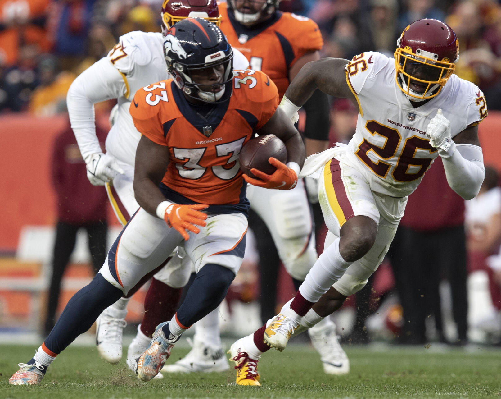 Denver Broncos running back Javonte Williams (33) runs down field for a first down at the Washington Football Team 15-yard line during the fourth quarter Sunday, Oct. 31, 2021, at Empower Field at Mile High in Denver. Denver won 17-10.(The Gazette, Christian Murdock) (Christian Murdock/The Gazette)