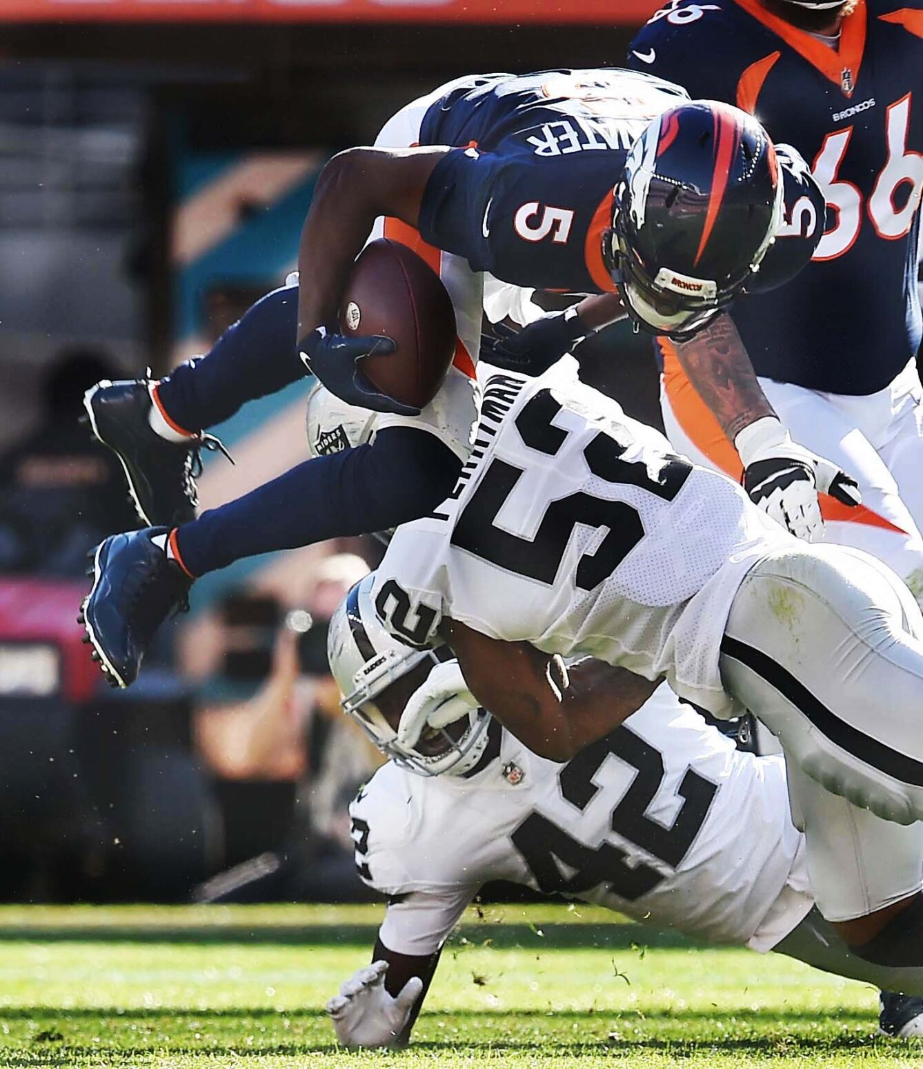 Broncos quarterback Teddy Bridgewater flies over Raiders linebackers Denzel Perryman and Cory Littleton for a first down in the third quarter of a game at Empower Field at Mile High Stadium on Sunday, Oct. 17, 2021. The Broncos were defeated 34-24. (Photo by Jerilee Bennett, The Gazette)