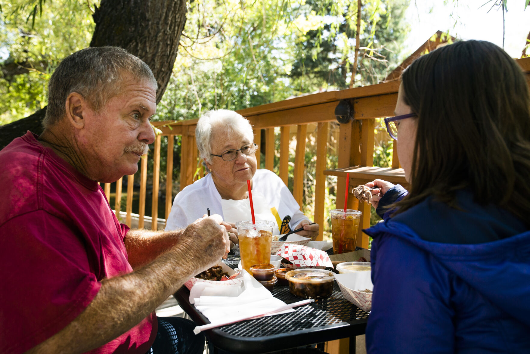 From left to right, Jim and Nancy Mundorf and their daughter, Lauren Bugbee, catch up while they eat their food on Friday, September 24, 2021 at Switchback Smokehouse in Kittredge. (Photo by Katie Klann/The Gazette) (Katie Klann The Gazette)