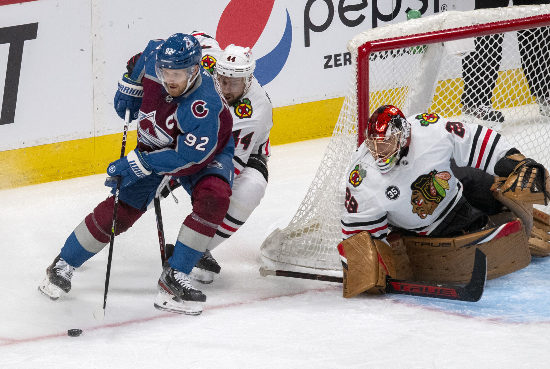 Colorado Avalanche left wing Gabriel Landeskog (92) skates behind the Chicago Blackhawks goal as Blackhawks defenseman Calvin de Haan (44) and goaltender Marc-Andre Fleury (29) defends during the first period Wednesday, Oct. 13, 2021, at the Ball Arena in Denver. (The Gazette, Christian Murdock) (Christian Murdock/The Gazette)