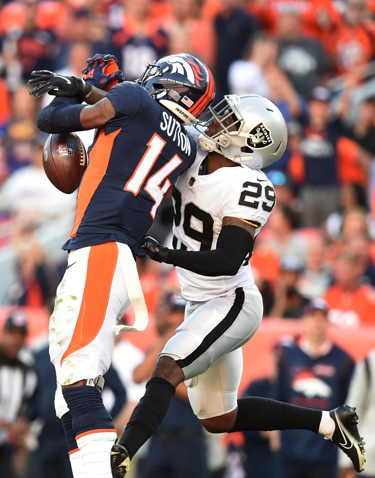 Broncos wide receiver Courtland Sutton drops the ball while being defended by Raiders safety Tre’von Moehring during the third quarter of a game against the Raiders at Empower Field at Mile High Stadium on Sunday, Oct. 17, 2021. The Broncos were defeated 34-24. (Photo by Jerilee Bennett, The Gazette)
