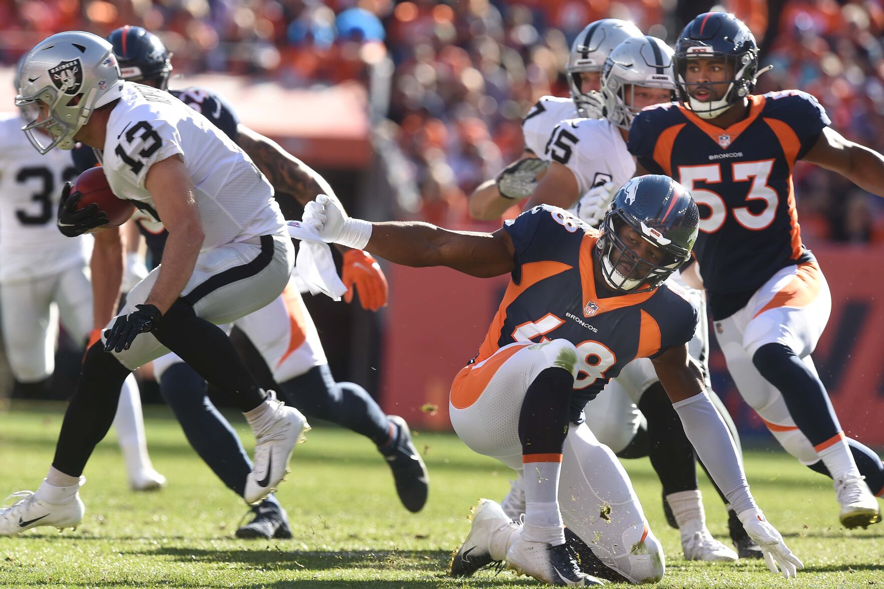 Broncos linebacker Andre Mintze tries to stop Raiders Hunter Renfrow. The Broncos lost to the Raiders 34-24 on Sunday, Oct. 17, 2021 at Empower Field at Mile High Stadium. (Photo by Jerilee Bennett, The Gazette) (Jerilee Bennett)