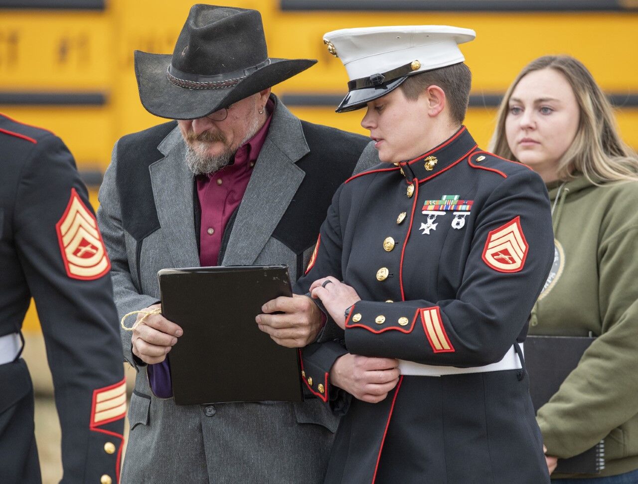 U.S. Marine Staff Sgt. Tori Kemper, Casualty Officer with the Salt Lake City Inspector-Instructor Staff & Rifle Company F (-) 2d Battalion, 23rd Marines, escorts Jim McCollum to memorial services for his son, Lance Cpl. Rylee McCollum, on Saturday at the Gill Ranch in Jackson, Wyo. (Bradly J. Boner, Jackson Hole News&Guide)