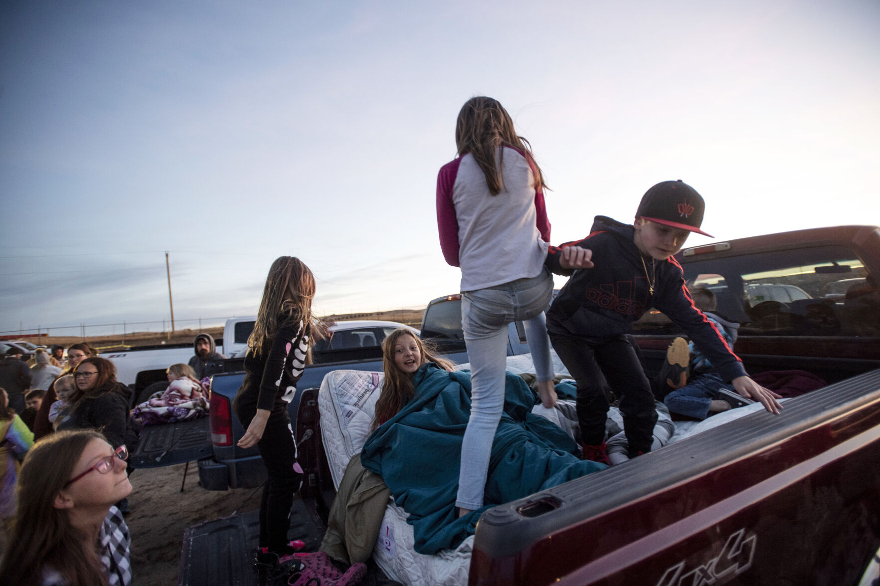 Children play in the back of a pickup before the start of the Cabin Fever Laser Show at the El Paso County Fairgrounds in Calhan, Colo., on Friday, Oct. 22, 2021. The drive-in laser light show was started during the COVID-19 pandemic, offering a unique socially distance entertainment experience. The show includes 25 high-powered lasers and DUAL large screen Laser projection. The last show is Sunday at 7:30pm. (Chancey Bush / The Gazette) (Chancey Bush/ The Gazette)
