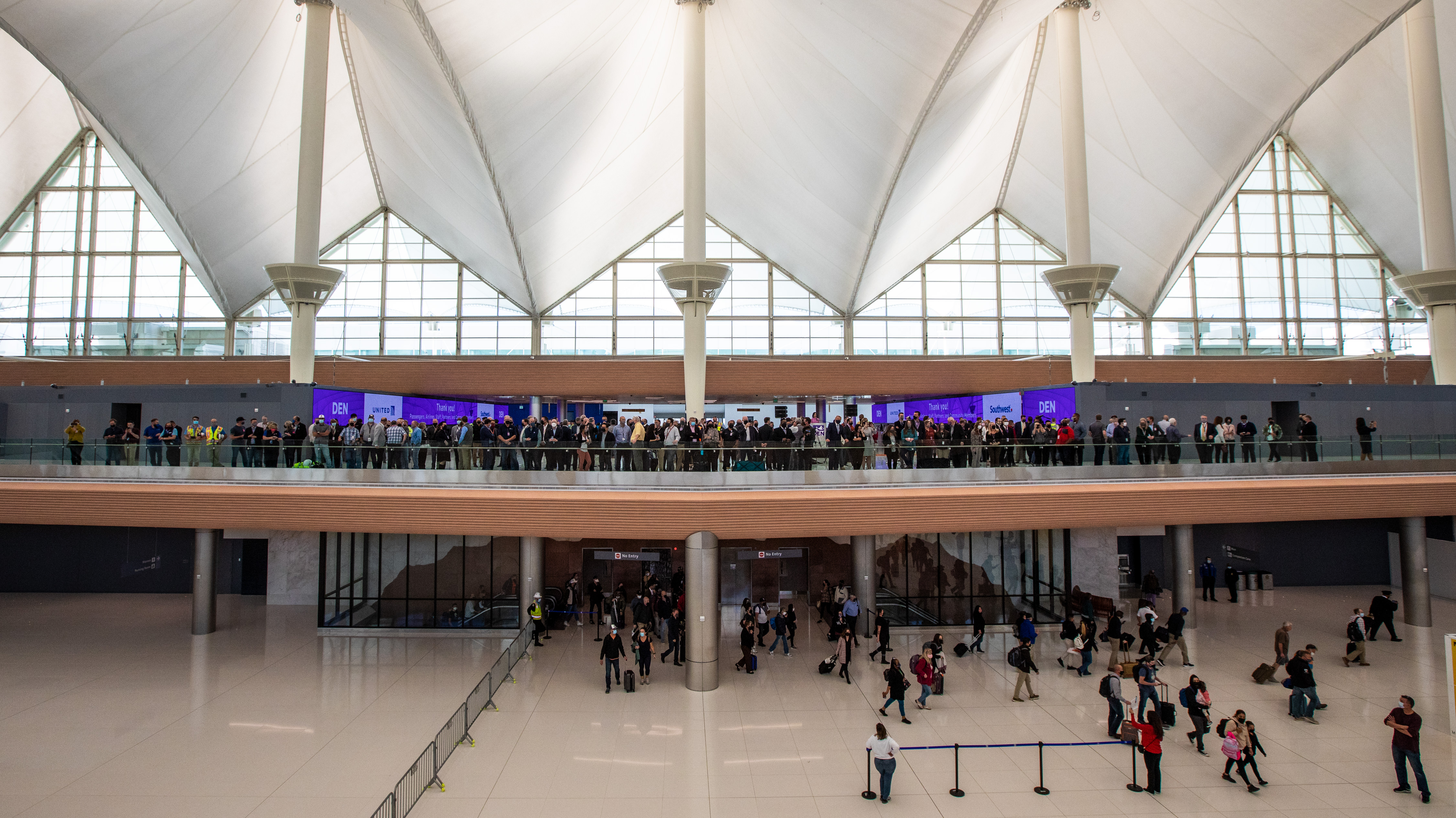 Officials and media represenatives on level 6, prepared for the ribbon cutting to mark the completion of phase one of the Great Hall improvements. The improvements added 86 check-in stations for United and Southwest airlines. (Courtesy of DIA, Peter Scott Barta)