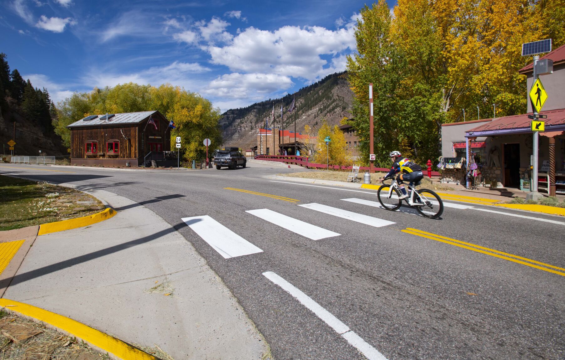 A cyclist rides through the small mountain town of Minturn this month. (Christian Murdock/The Gazette)