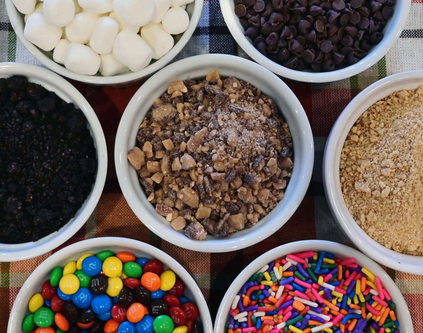 Some of the toppings that can be used with caramel apples. Made by Sweet Addict Bakery. (Jerilee Bennett, The Gazette)