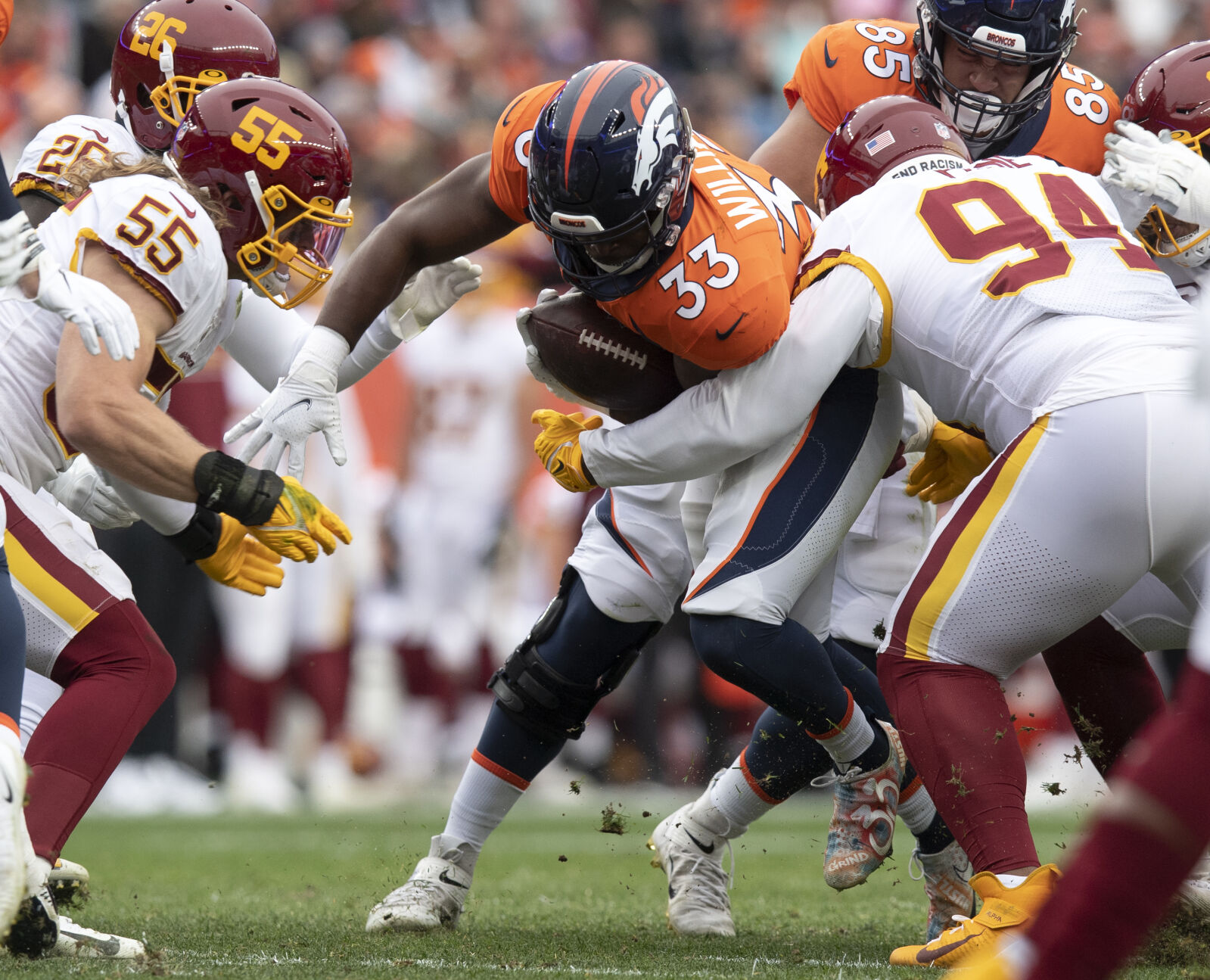 Denver Broncos running back Javonte Williams (33) runs for a gain as Washington Football Team defensive tackle Daron Payne (94) tackles him during the first quarter Sunday, Oct. 31, 2021, at Empower Field at Mile High in Denver. (The Gazette, Christian Murdock) (Christian Murdock/The Gazette)