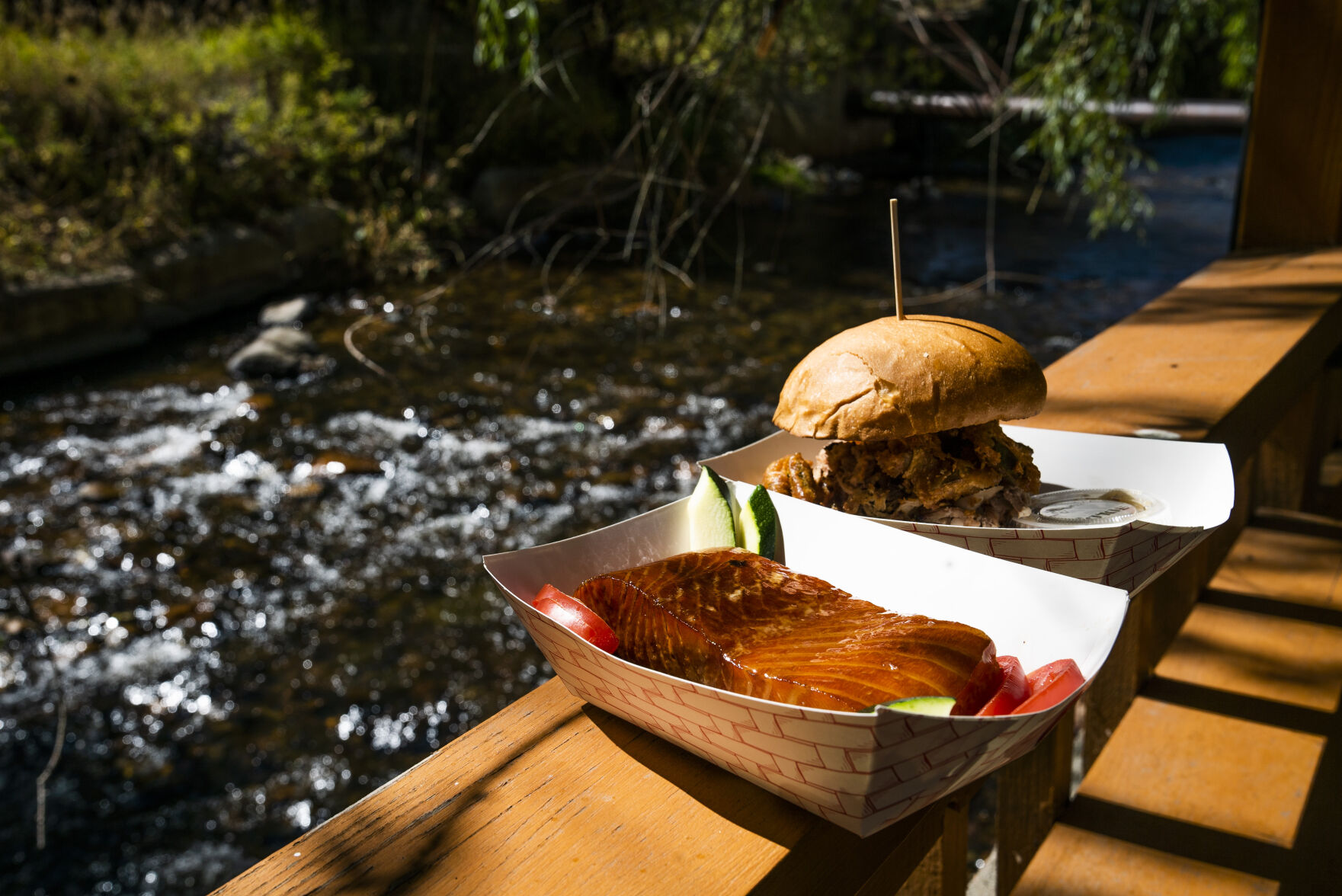 Bourbon-glazed salmon and The Devil’s Elbow sandwich next to the river at Switchback Smokehouse in Kittredge. (photos by Katie Klann, The Gazette)