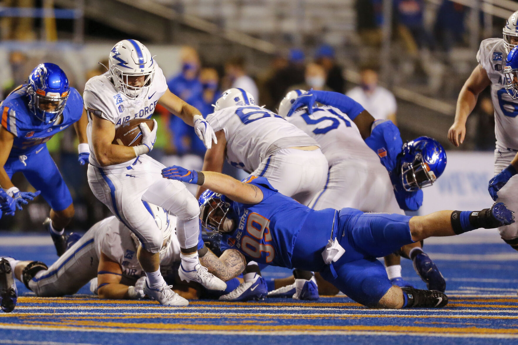 Air Force running back Brad Roberts, left, pulls away from the tackle attempt of Boise State defensive tackle Scott Matlock, right, on Saturday in Boise, Idaho. (the associated press)