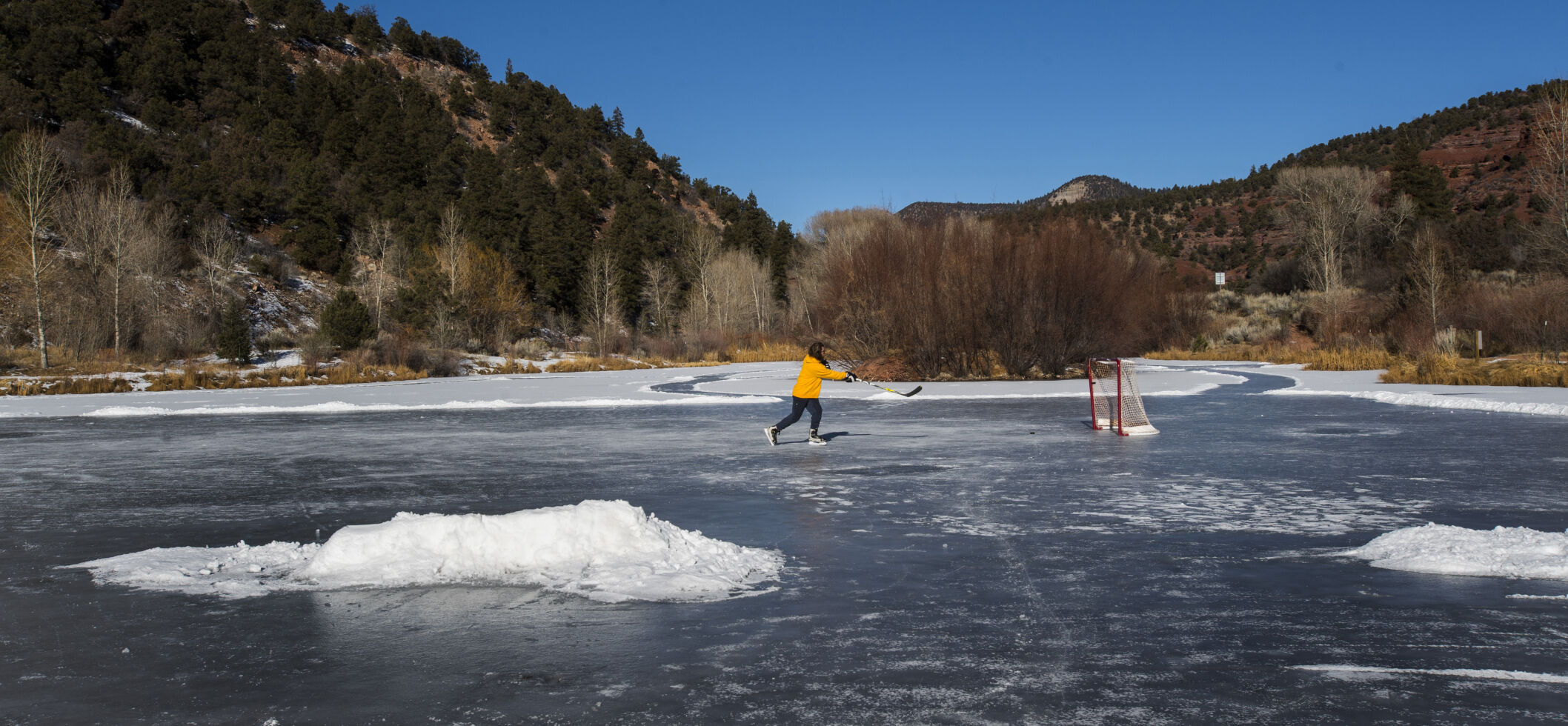 Greg Sederberg of Telluride, Colo., plays hockey on a frozen pond in the Down Valley Park along State Highway 145 north of town Sunday, Jan. 14, 2018. Seberberg, who grew up in North Dakota, brought his own goal to the park to play on a sunny morning. (The Gazette, Christian Murdock) (Telluride, Colo. Christian Murdock)