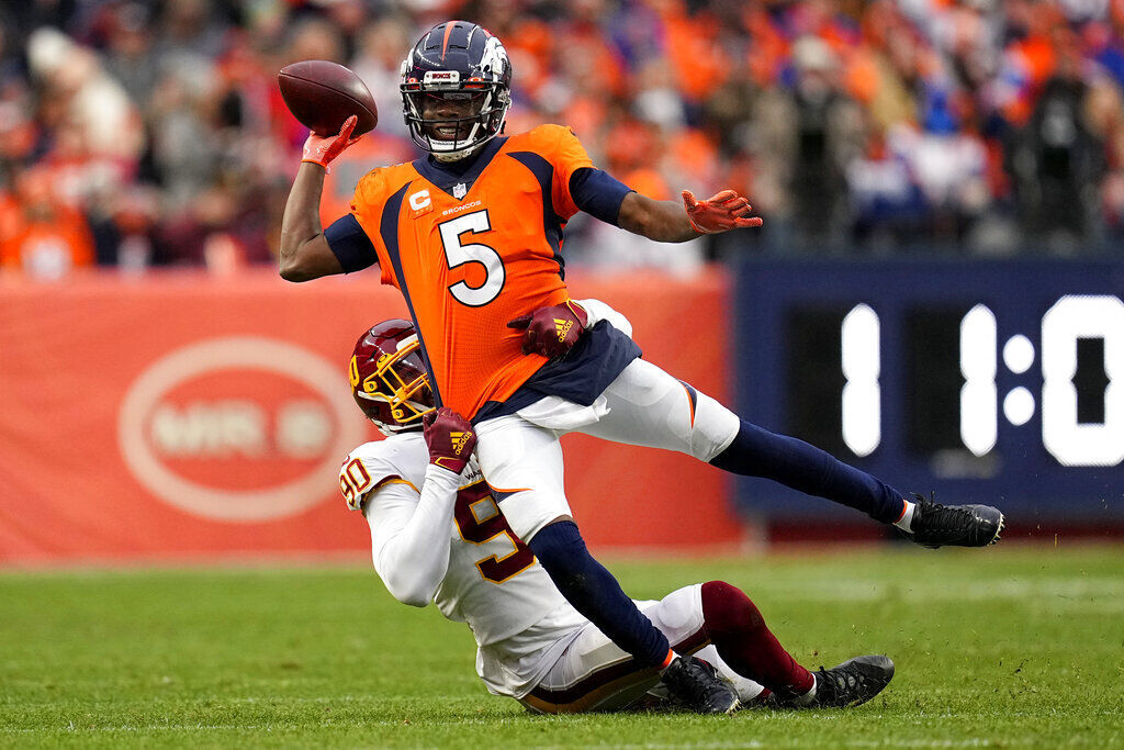 Denver Broncos quarterback Teddy Bridgewater (5) gets the ball away as Washington Football Team defensive end Montez Sweat (90) pulls him down during the second half of an NFL football game, Sunday, Oct. 31, 2021, in Denver. (AP Photo/Jack Dempsey) (Jack Dempsey)