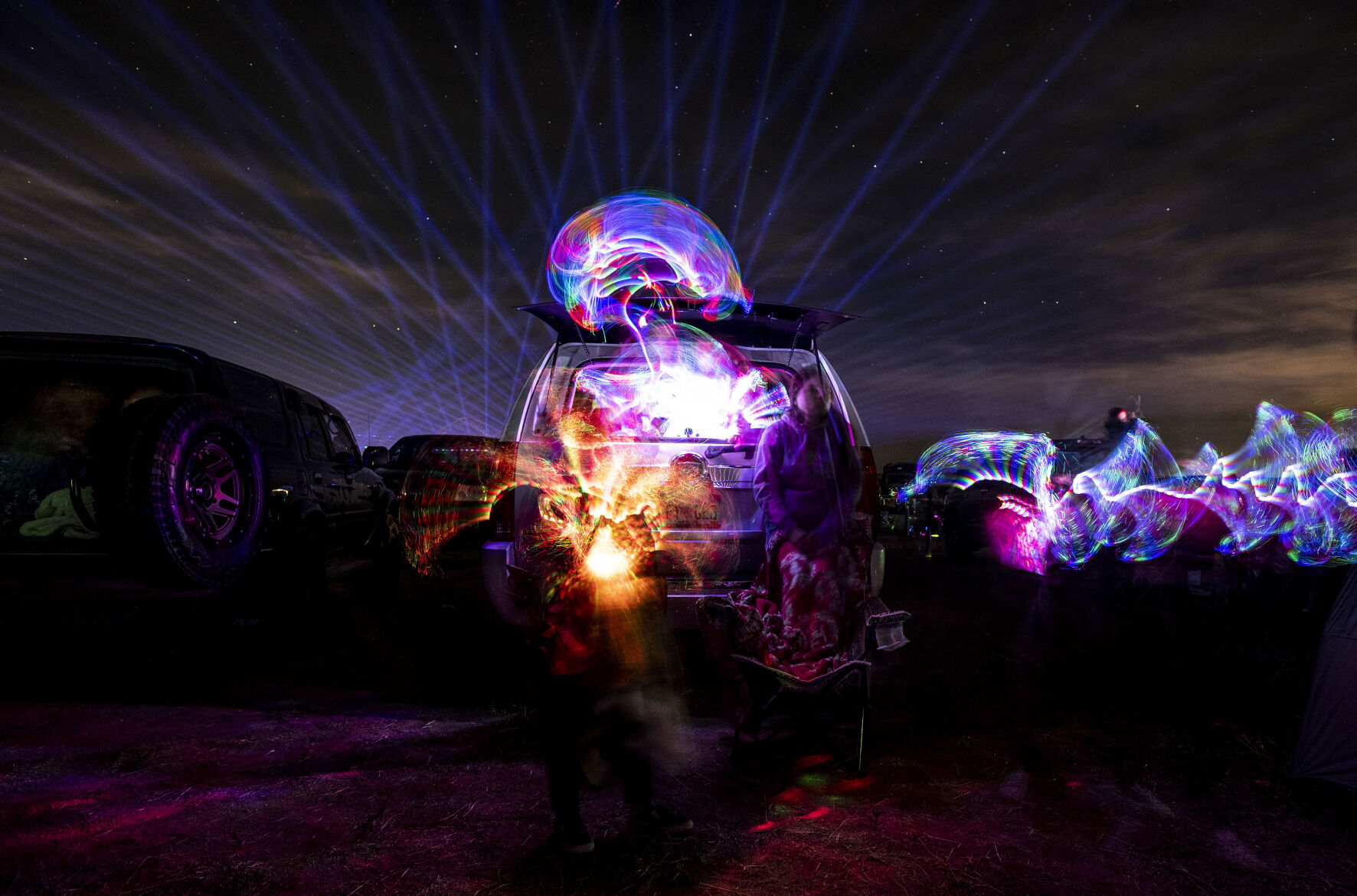 The Reyes family, from Colorado Springs, watch the Cabin Fever Laser Show at the El Paso County Fairgrounds in Calhan, Colo., on Friday, Oct. 22, 2021. The drive-in laser light show was started during the COVID-19 pandemic, offering a unique socially distance entertainment experience. The show includes 25 high-powered lasers and DUAL large screen Laser projection. The last show is Sunday at 7:30pm. (Chancey Bush / The Gazette) (Chancey Bush/ The Gazette)